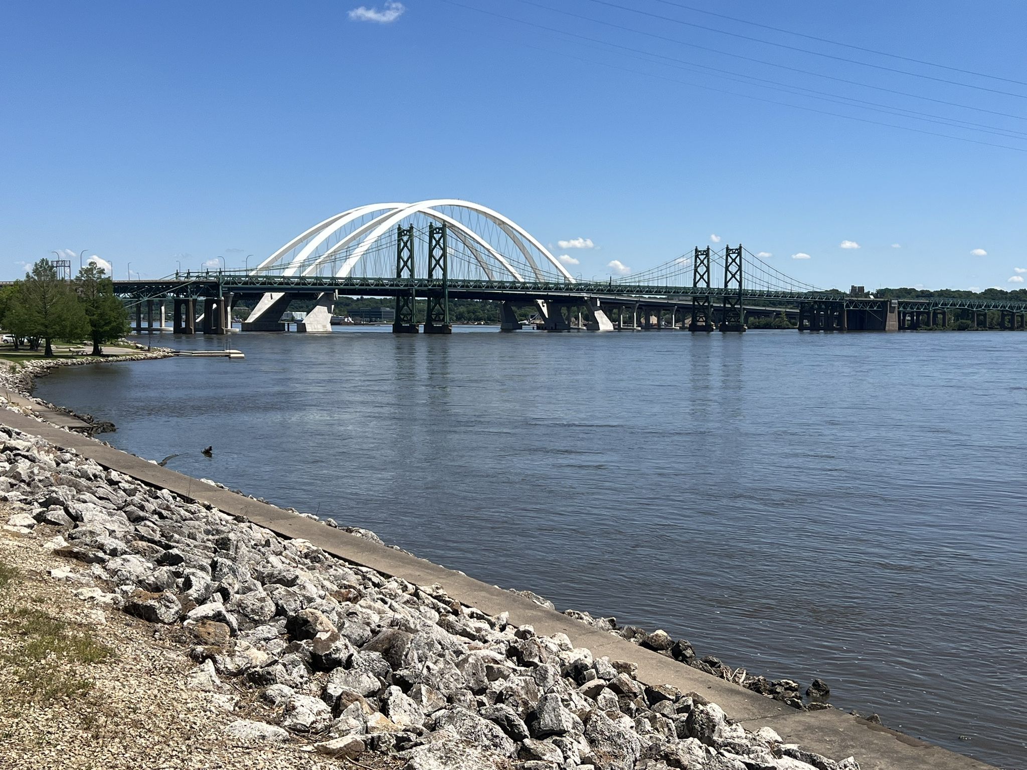 Wide river with a large arched bridge under a bright blue sky. - Duck Creek Trail – Sunderbruch Park loop from Panorama Park