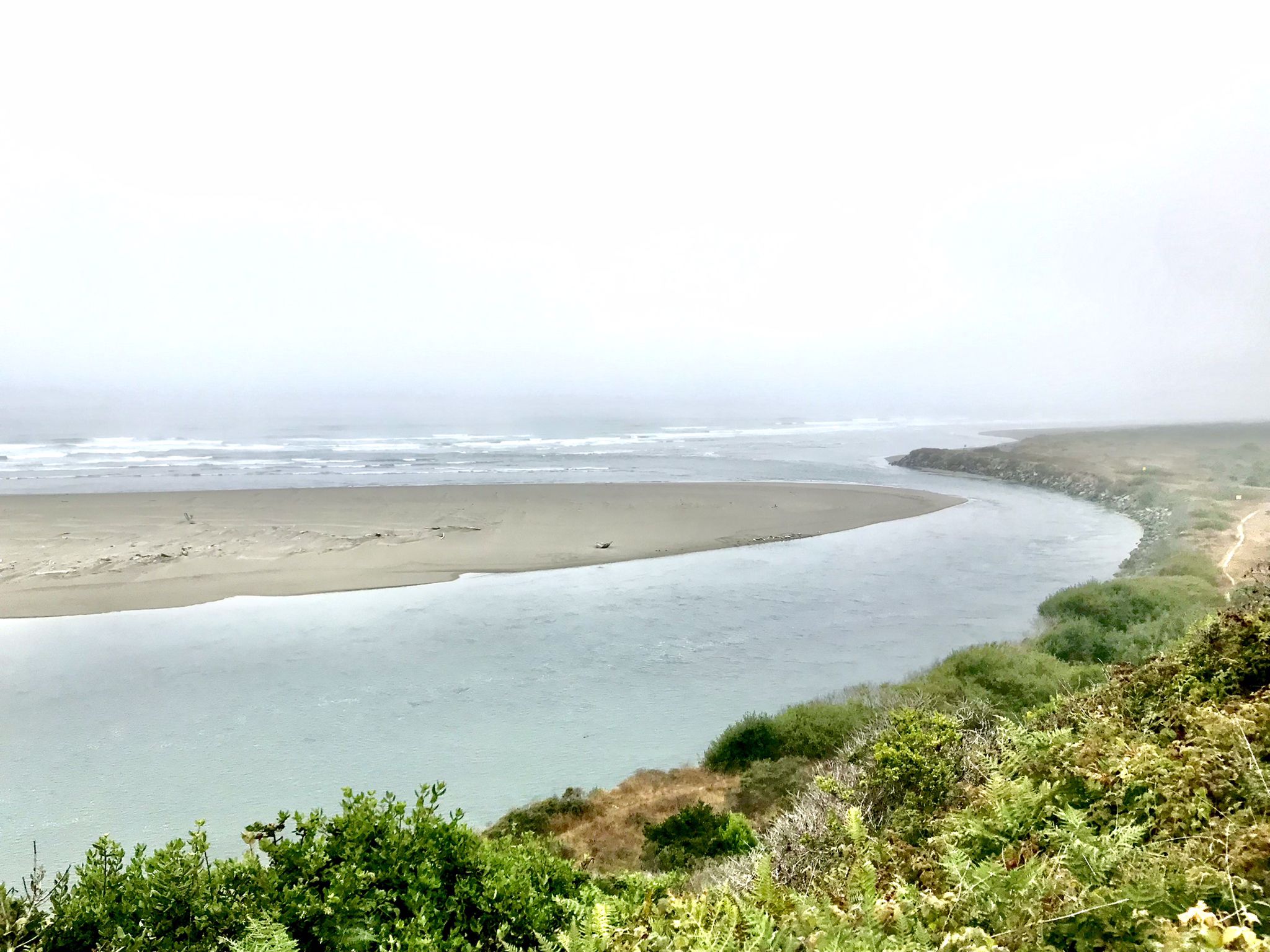 River estuary meeting the ocean on a foggy, overcast day. - Arcata Plaza – Trinidad Lighthouse loop from Arcata