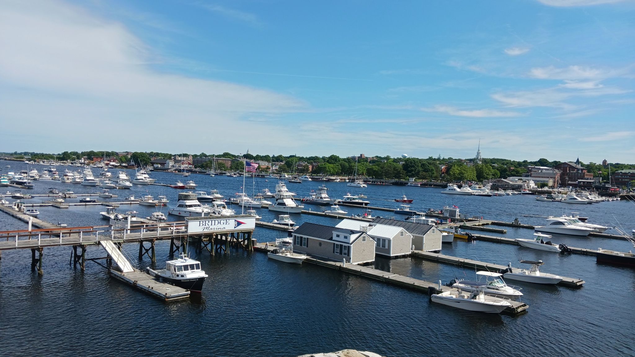Aerial view of a busy marina with numerous boats under a bright sky. - Hampton Harbor – Gillis Bridge loop from Hampton Beach