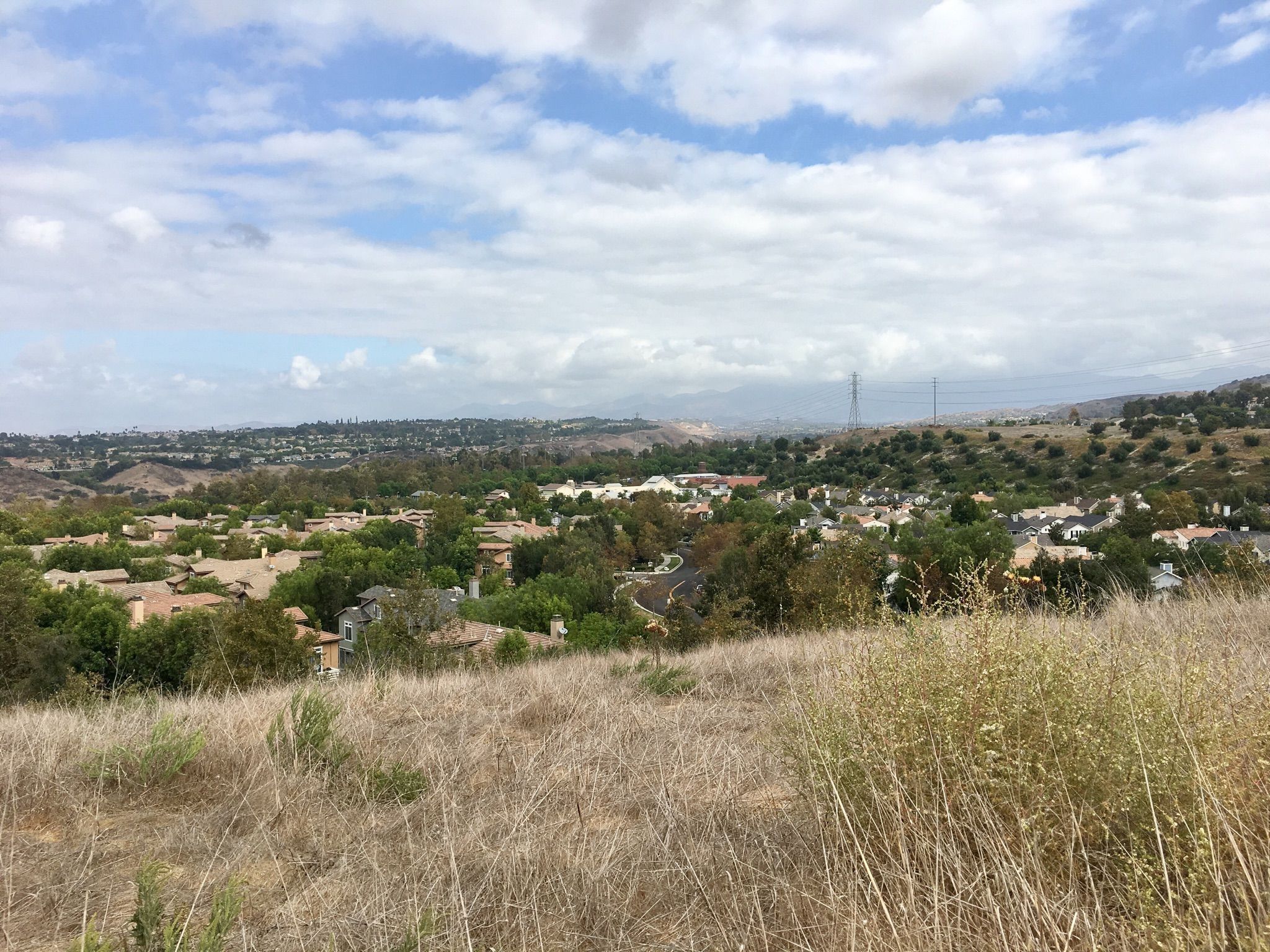 Panoramic view of a residential area nestled in hills under a cloudy sky. - Ladera Ranch, Arroyo Trabuco, and Trabuco Ridge Loop