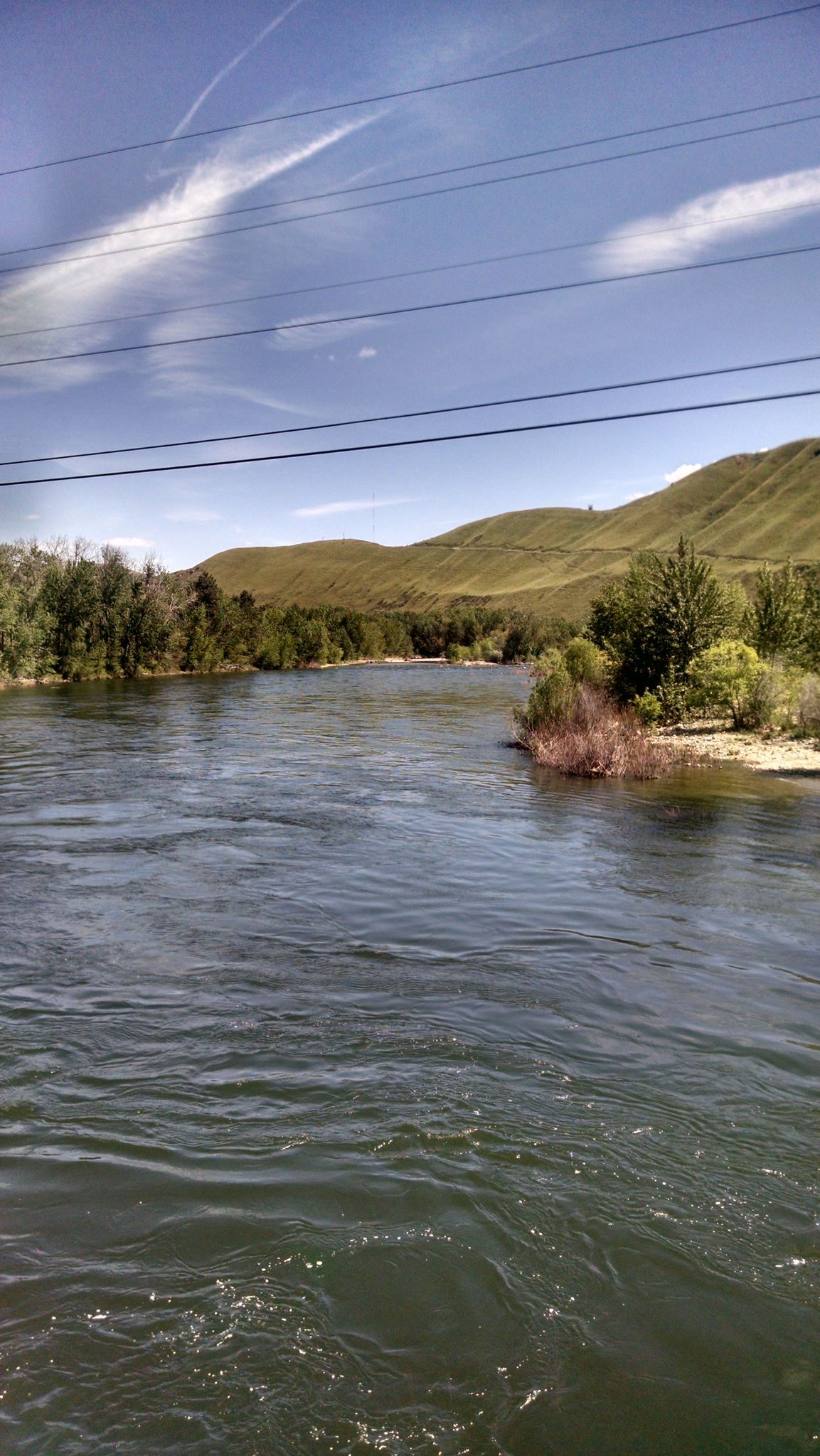 A wide river with green hills and trees under a bright blue sky. - Cashmere to Wenatchee Confluence State Park