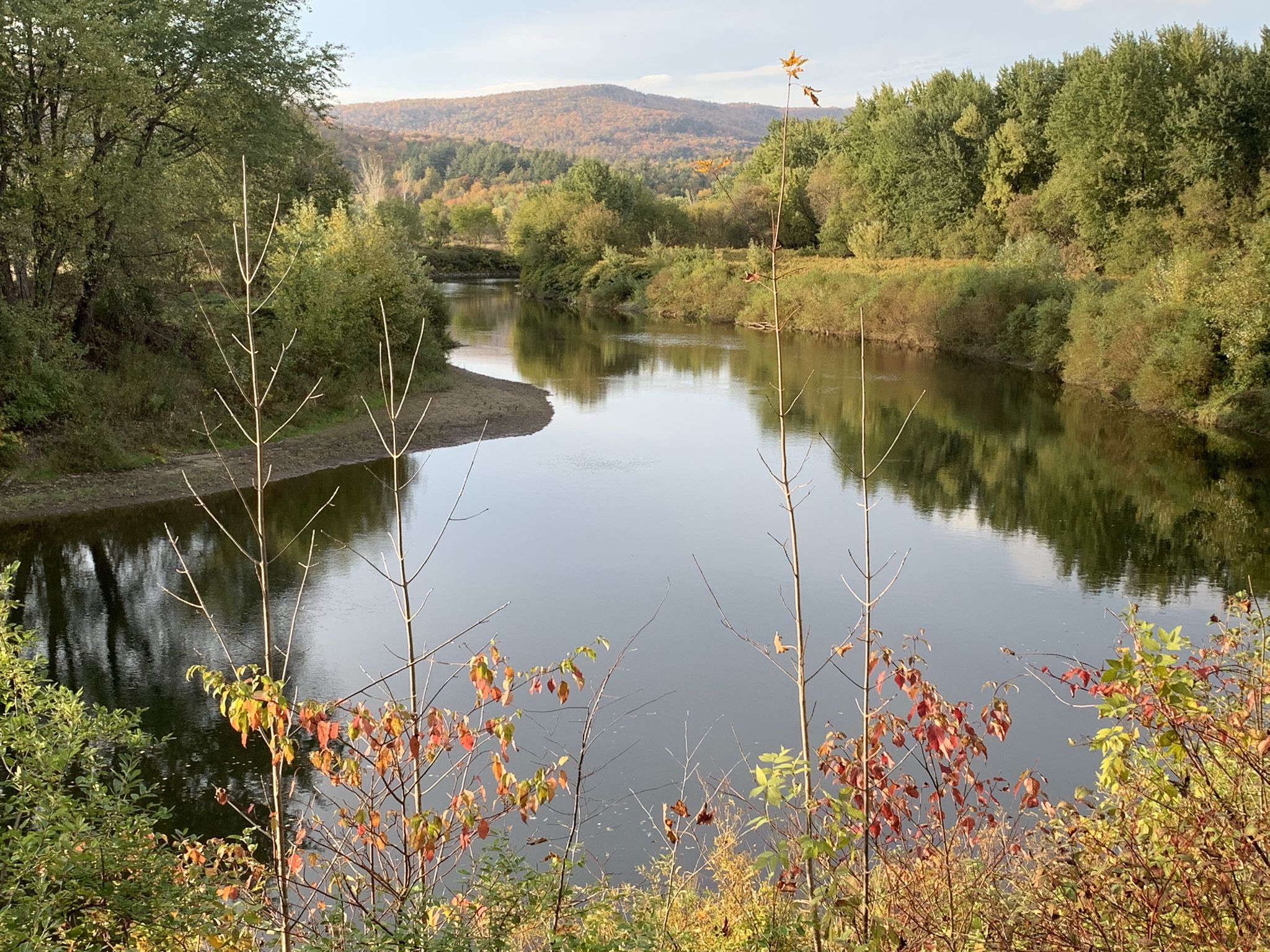 A winding river flows through a valley with green and autumn trees. - Dog’s Head Falls – Old Railroad Bridge loop from Morristown Park and Ride