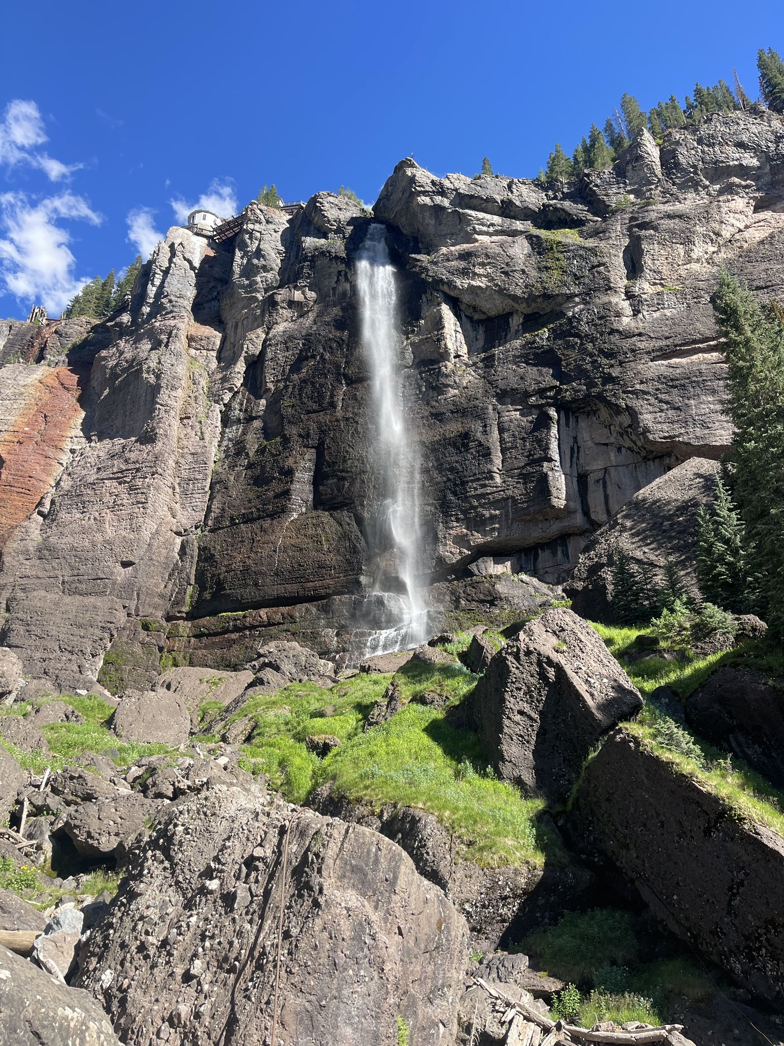 Majestic waterfall plunging from a towering cliff into a rocky basin. - Ajax Peak – Valley View loop from Bridal Veil Falls