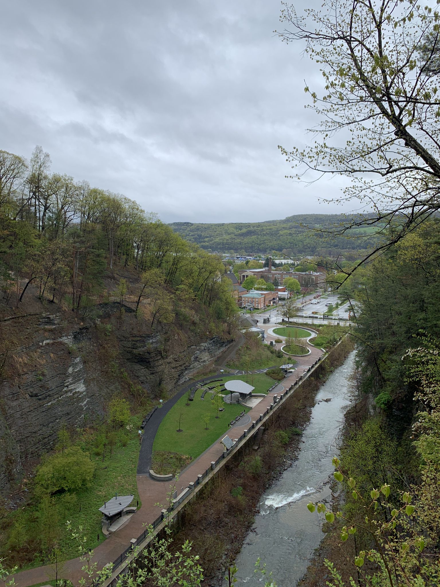 Overcast view of a river and park area in a wide, green valley. - Gorge and Indian Trail