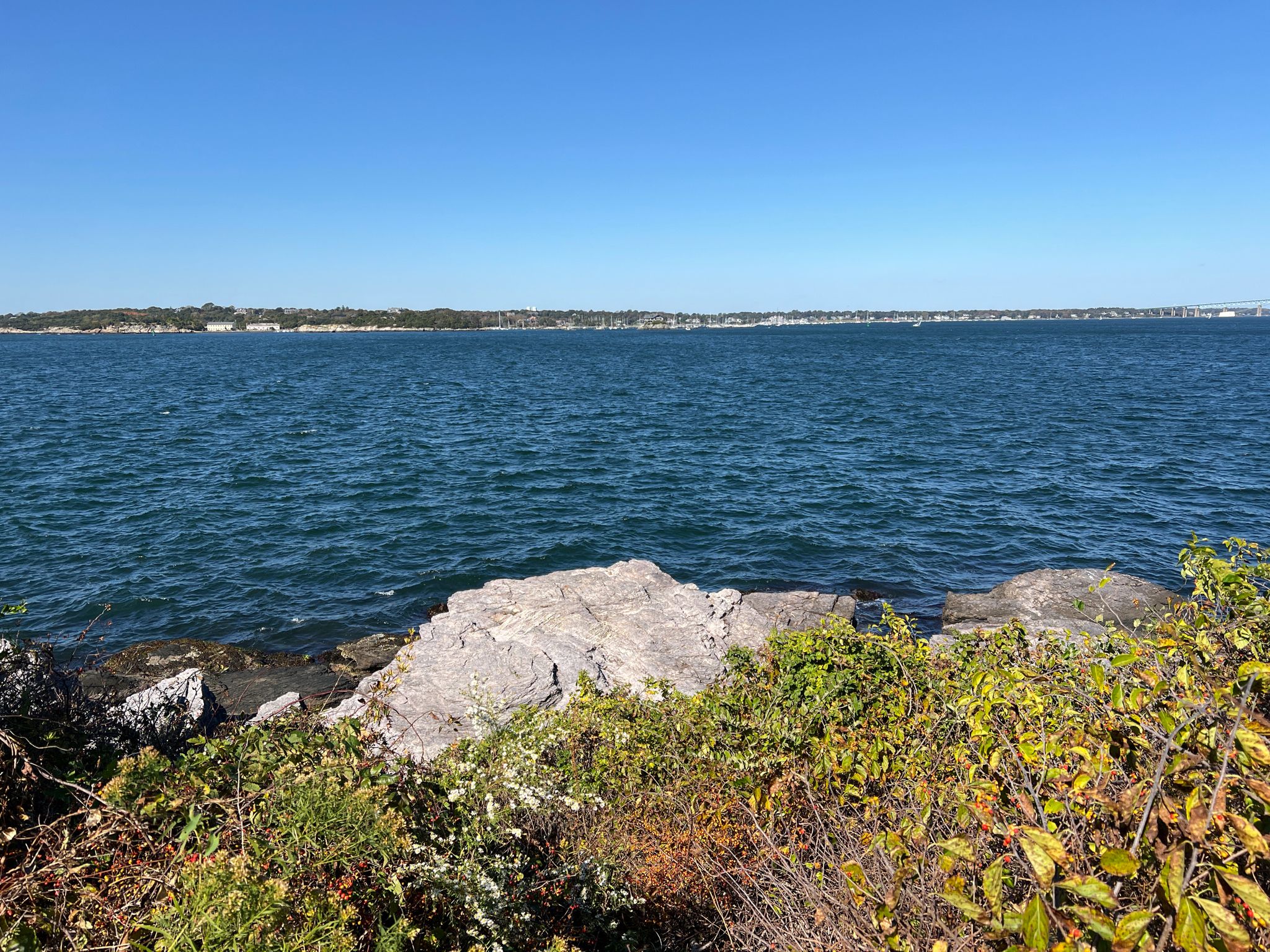 Expansive blue ocean view with rocky foreground and distant land under clear sky. - Hazard Beach – Portuguese Discovery Monument loop from St George's School