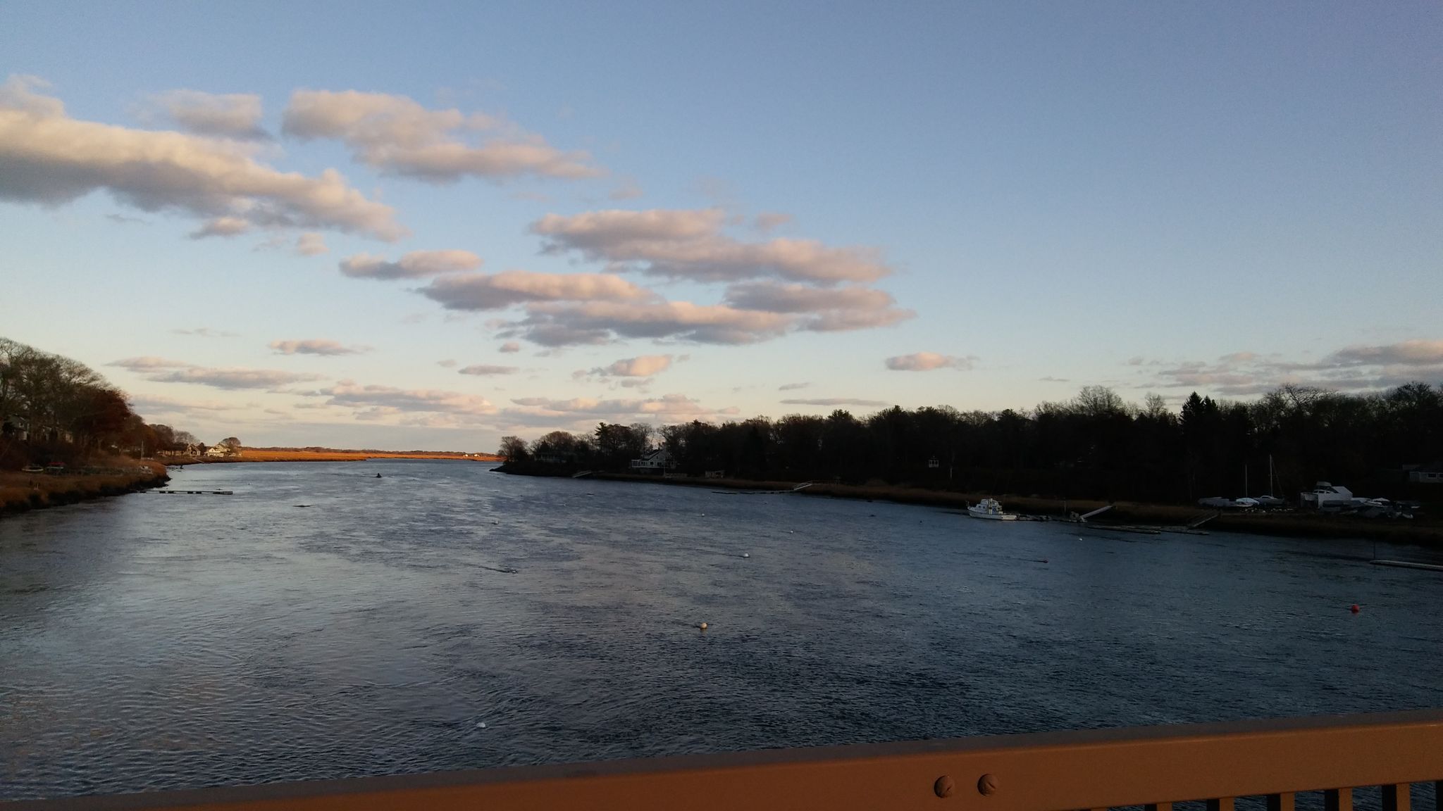 Wide river at sunset, with warm light on clouds and dark trees lining banks. - Parker River Bridge – Upper Artichoke Reservoir loop from Newburyport