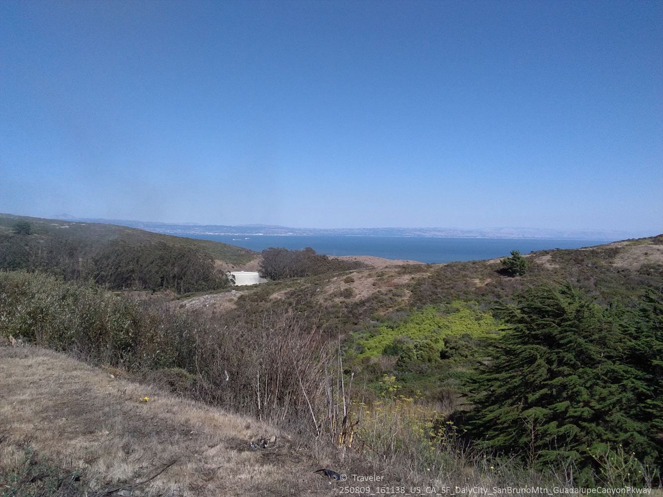 Rolling hills and distant ocean under a bright, clear blue sky. - Guadeloupe Canyon Parkway – Guadelupe Canyon Parkway loop from Daly City