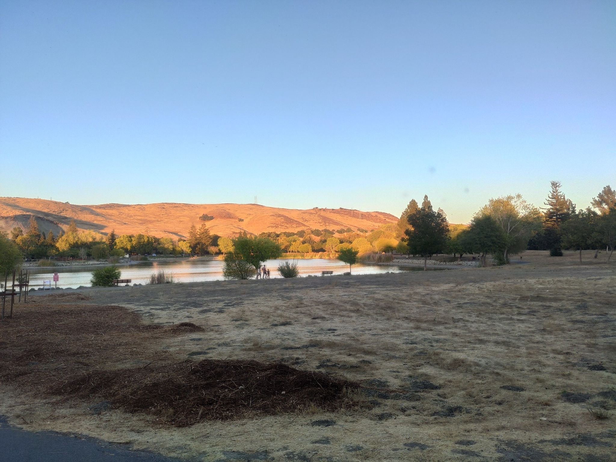 Expansive view of a lake with distant hills at sunset, golden light. - Hellyer Velodrome – Hellyer County Park loop from Eastridge Transit Center