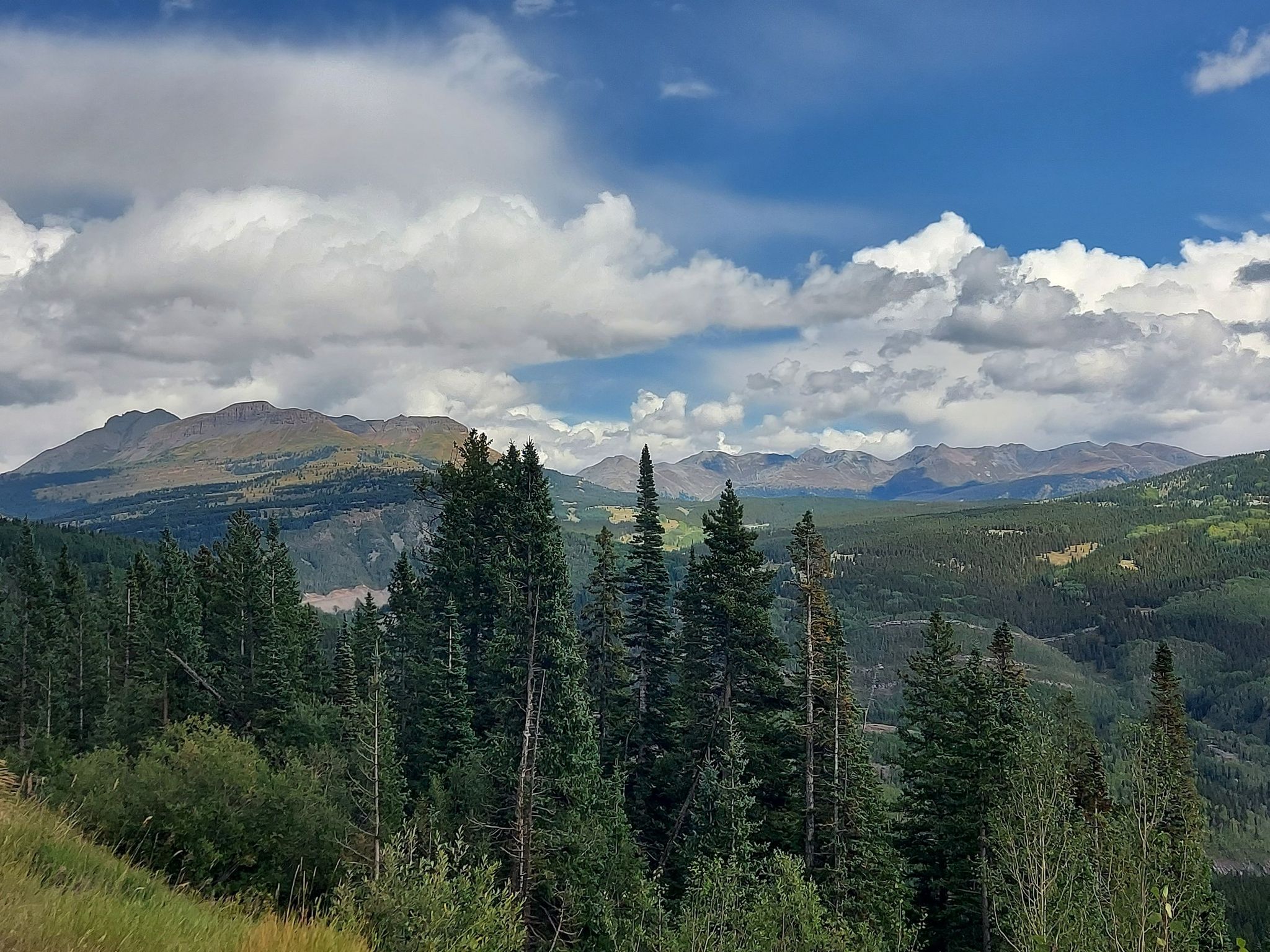 Vast mountain landscape with dense evergreen forests under a partly cloudy sky. - Engineer Mountain and Pass Creek Trail Loop