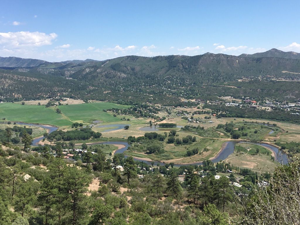 Panoramic view of a winding river through a green valley with distant mountains. - Animas Mountain Upper Loop