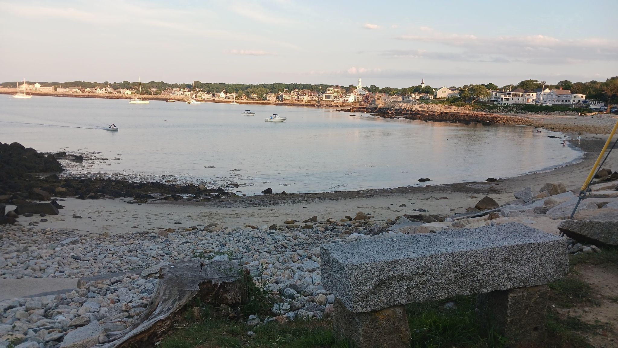 Sandy beach with boats in a calm bay, houses, and golden light. - Halibut Point State Park – Annisquam Footbridge loop from Salt Island