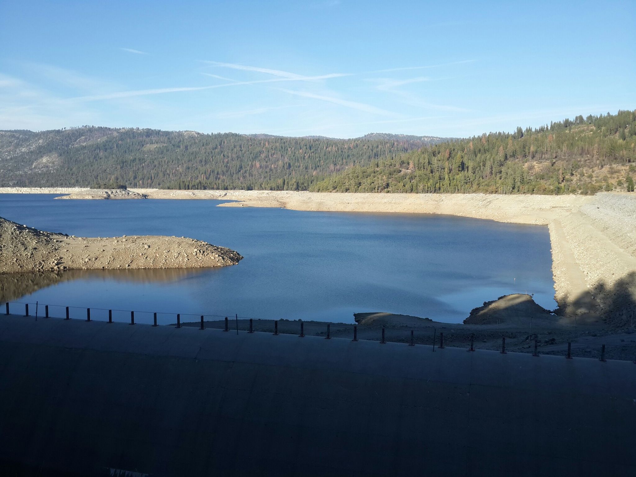 Wide view of a lake with exposed banks and distant forested hills. - Lake Eleanor and Cherry Lake