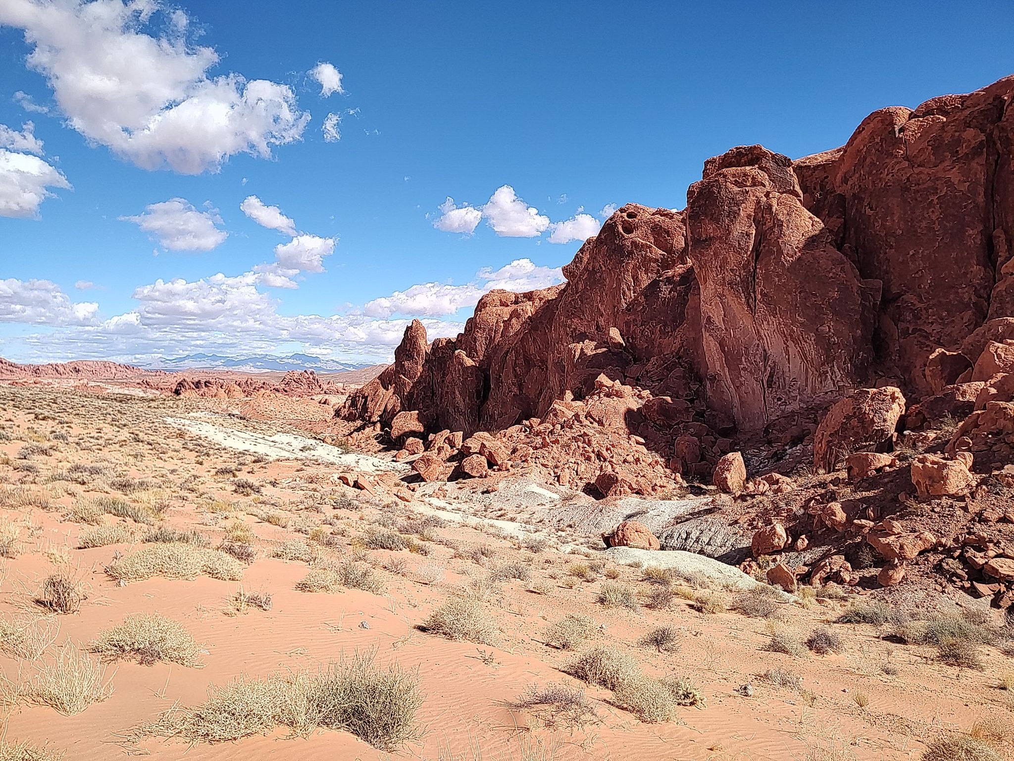 Expansive desert with red rock formations, sandy ground, and blue sky. - Fire Wave – Pink Canyon loop from Valley of Fire State Park