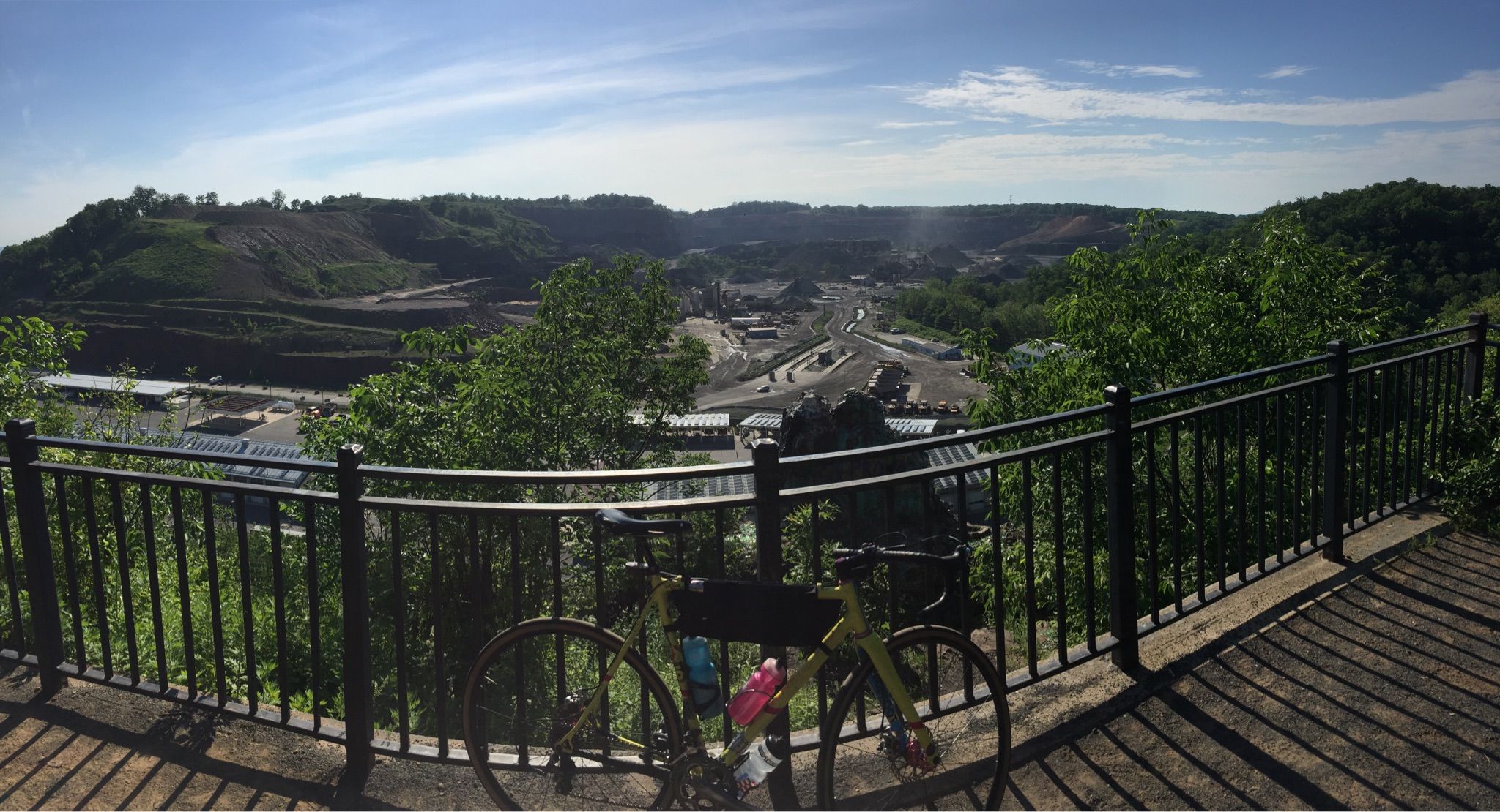 Bicycle parked at an overlook with a vast view of hills and industry. - Washington Valley Yellow and Green Top Loop