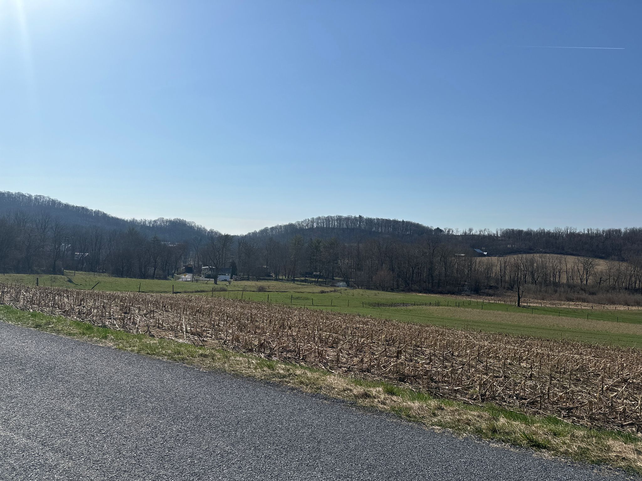 Sunny rural landscape with harvested fields, green pastures, and distant wooded hills. - Kutztown to Fleetwood loop
