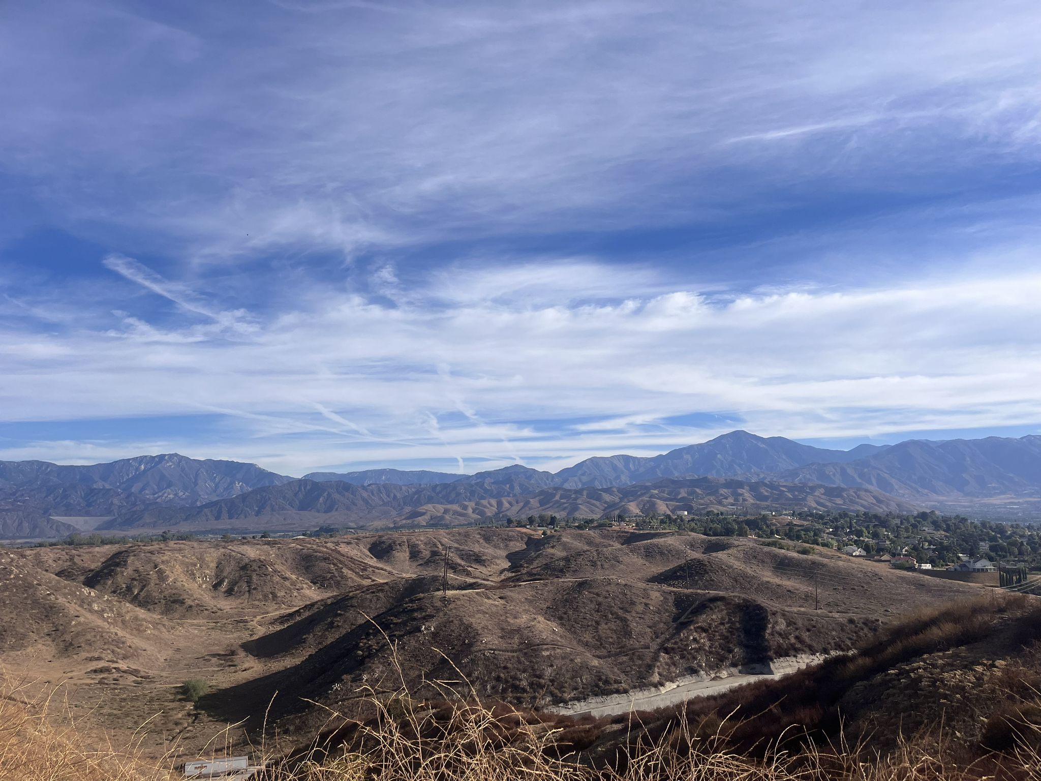 Rolling dry hills under a bright blue sky with distant mountains. - Panorama Point – Caroline Park loop from Herngt Aki Reserve