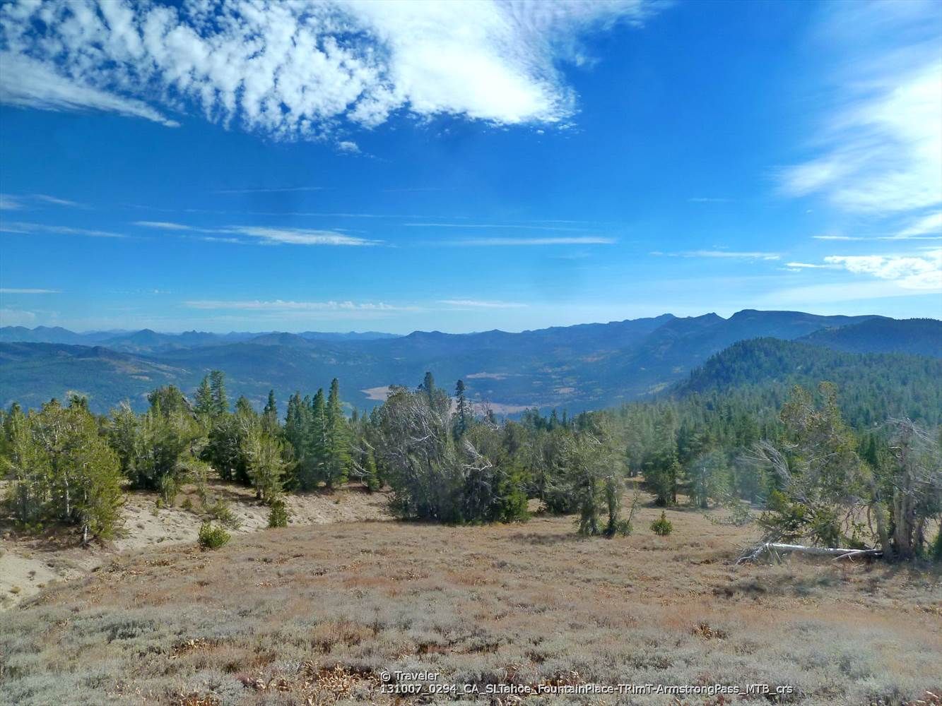 Expansive mountain landscape with scattered trees under a bright blue sky. - Tahoe Rim Trail: Armstrong Pass to Big Meadow