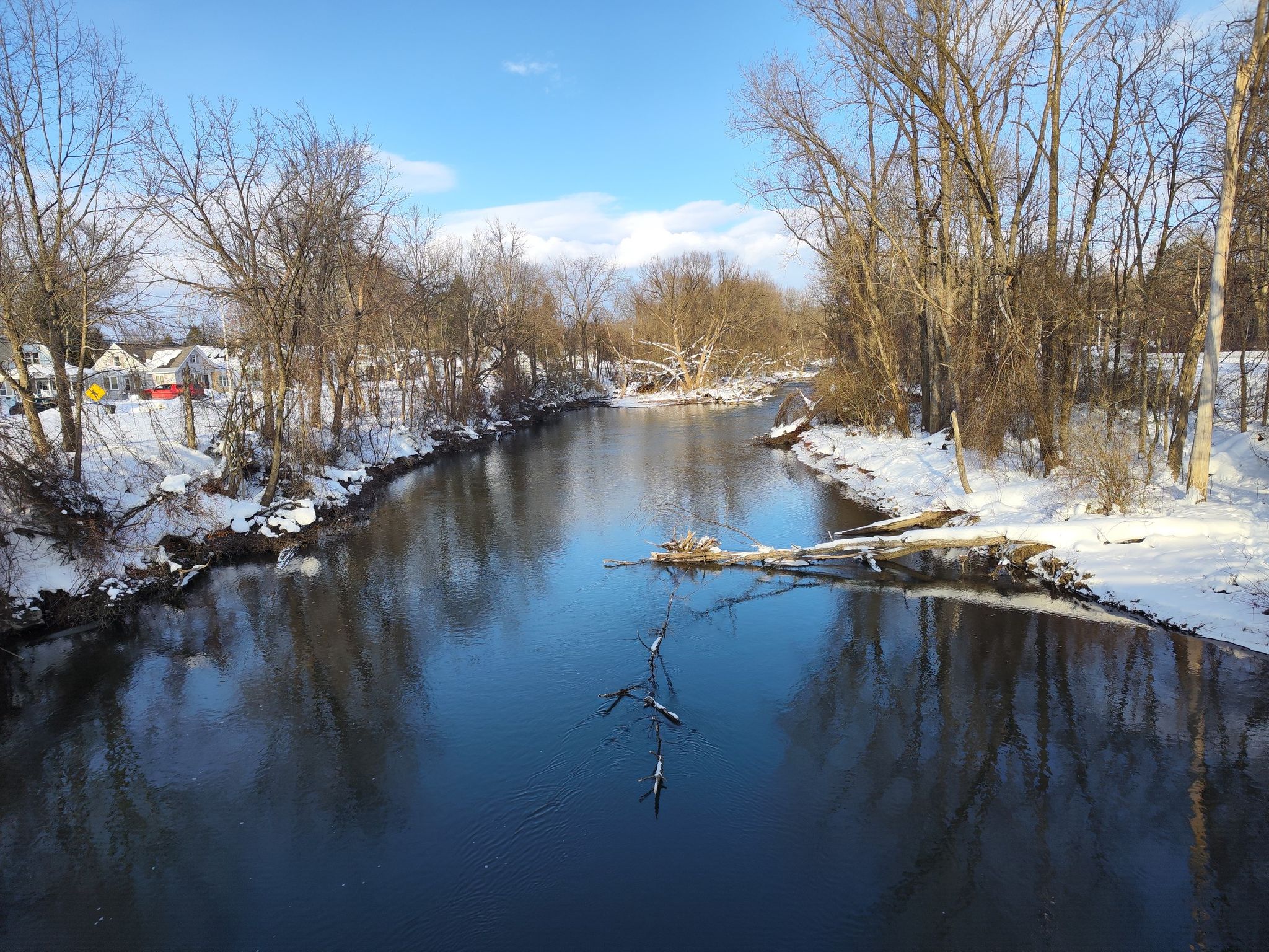 A winding river flows through a snowy winter landscape under a bright sky. - Mohawk River Trail – Fort Stanwix National Monument loop from City of Rome