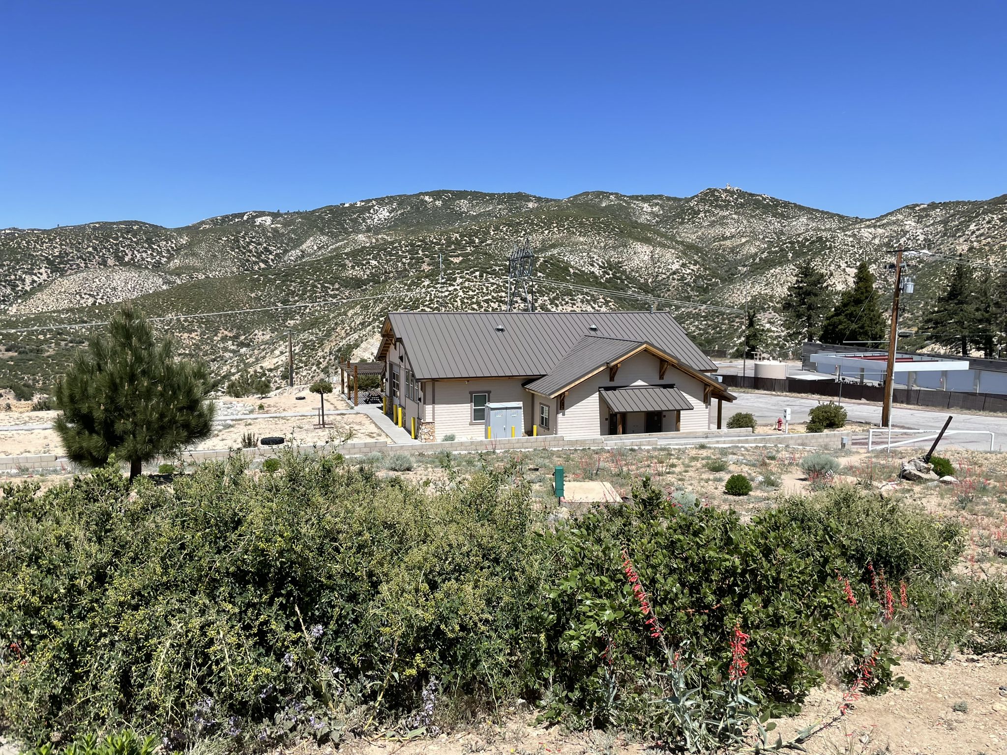 A building with a brown roof nestled in a scrubland mountain landscape. - Mill Creek Summit – Red Box Gap loop from Pony Park Trailhead (FEE AREA)