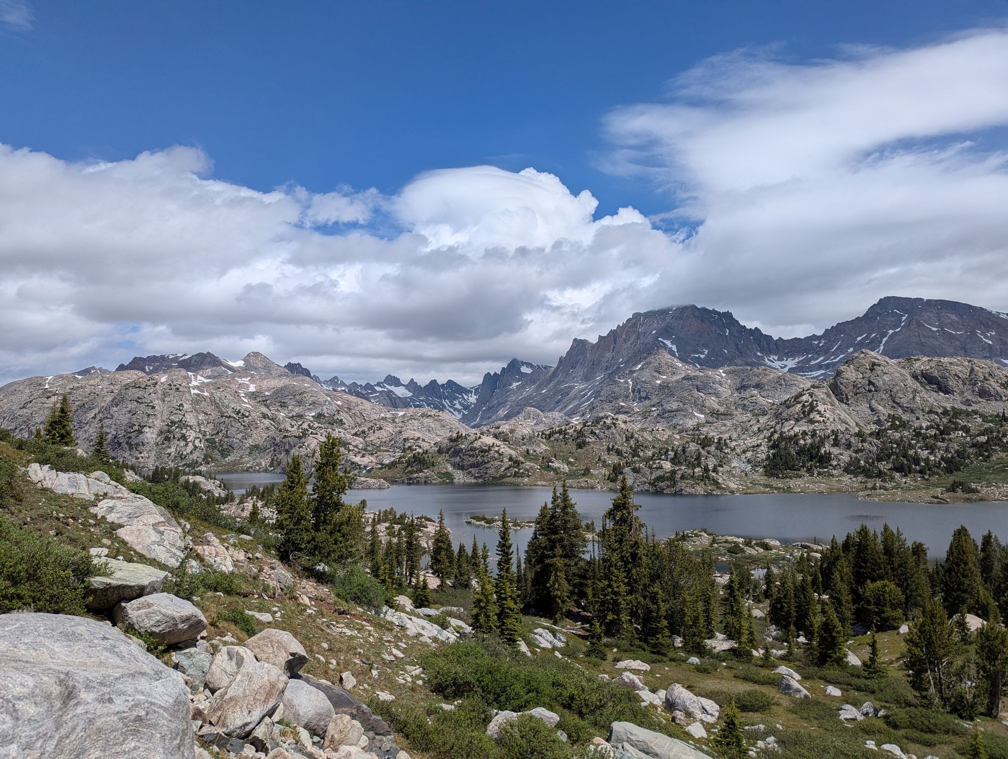 Vast lake and rugged mountains under a dramatic cloudy sky. - Island Lake via Pole Creek, Seneca Lake, and Indian Pass