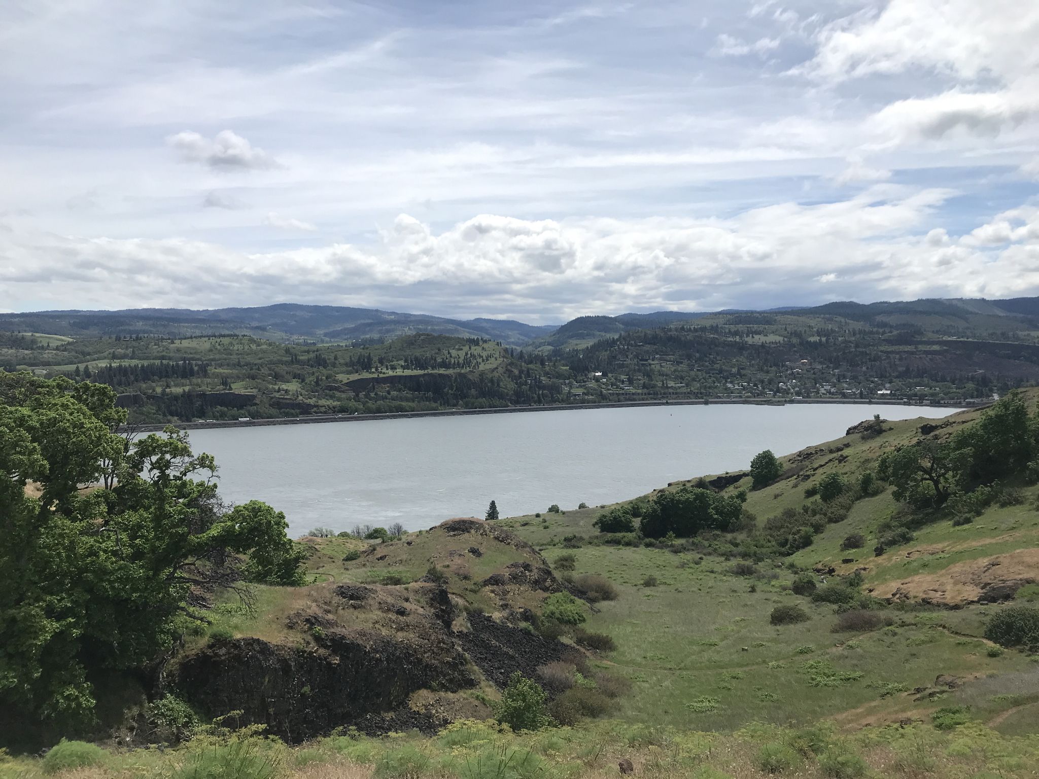 Wide view of a large lake surrounded by green, forested hills under cloudy sky. - Old Ranch Road and Little Maui Trail Loop