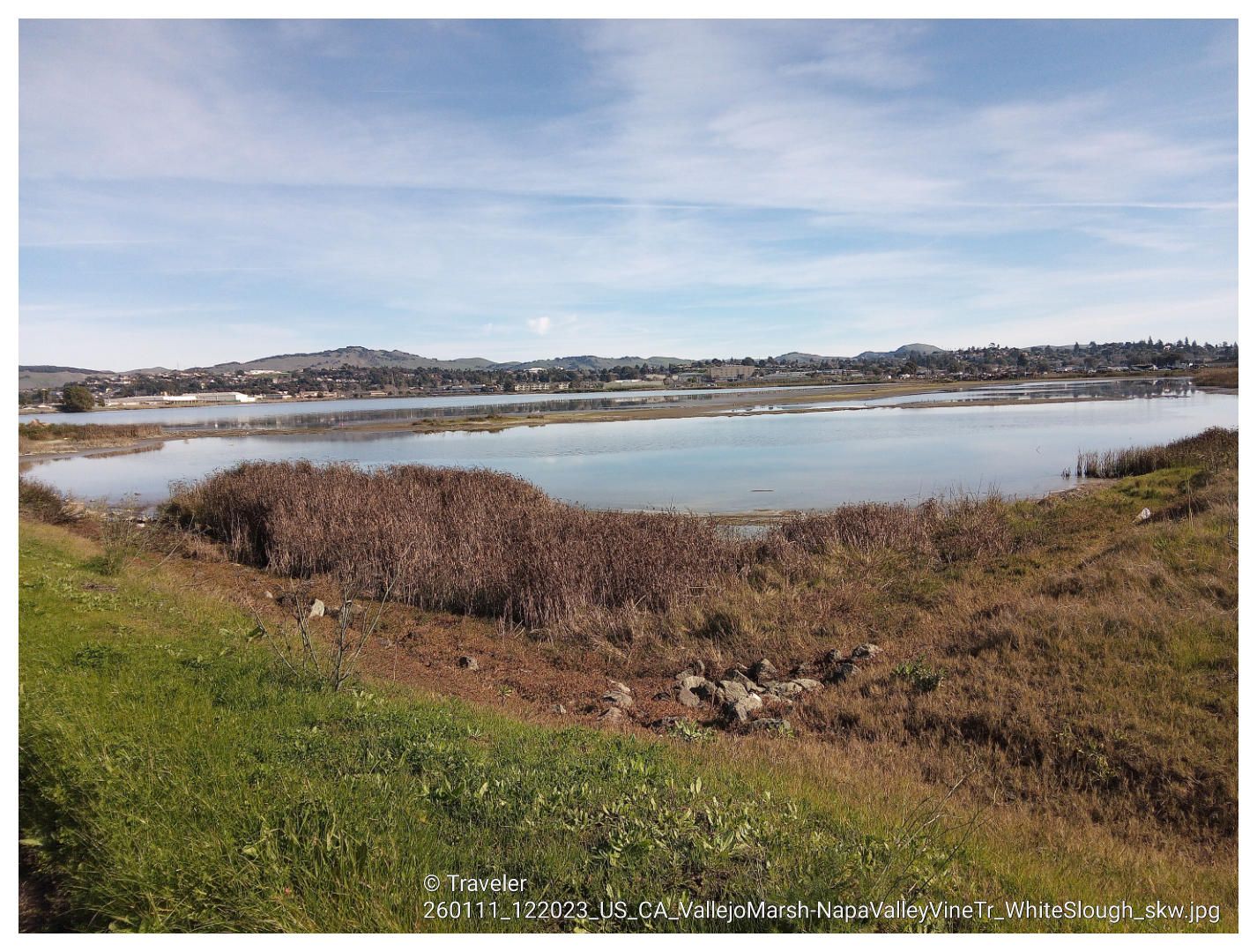 Wide view of a calm body of water with marshland and distant hills. - Vallejo to Sulphur Springs loop via Napa Valley Vine Trail
