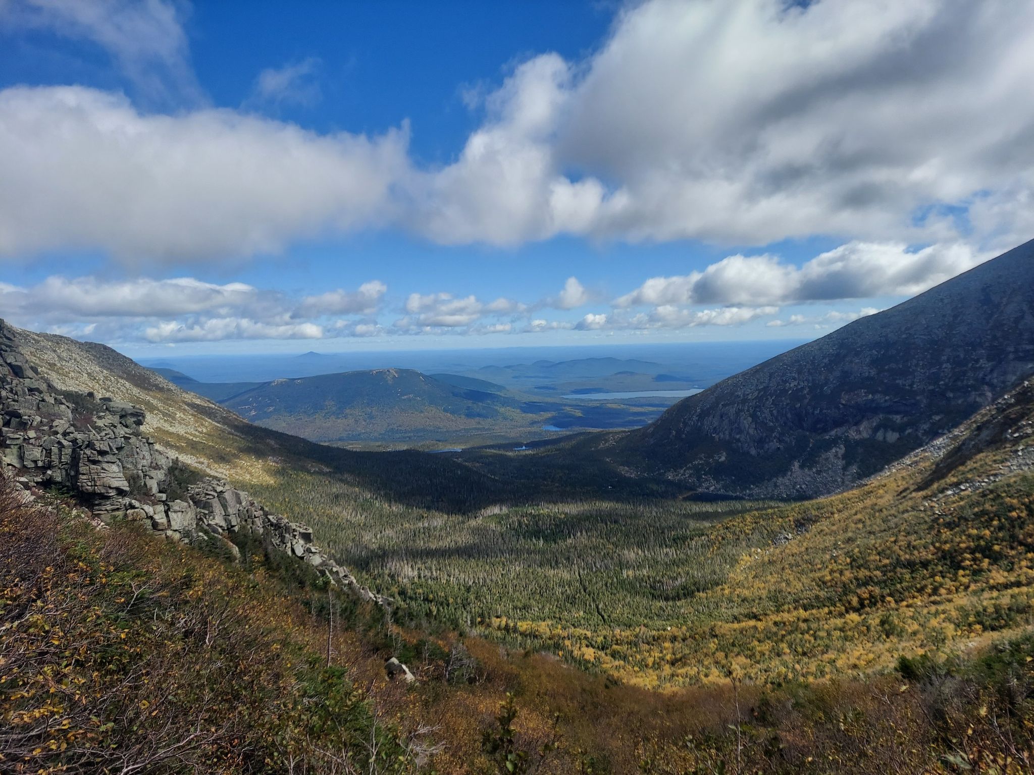 Wide mountain valley with forests, distant lakes, and cloudy sky. - Baxter Peak via Saddle and Cathedral Trail