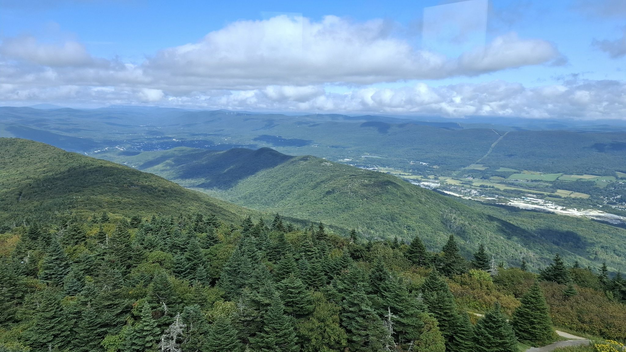 Vast green mountain landscape under a bright, cloudy blue sky. - Mount Greylock via Bellows Pipe Trail