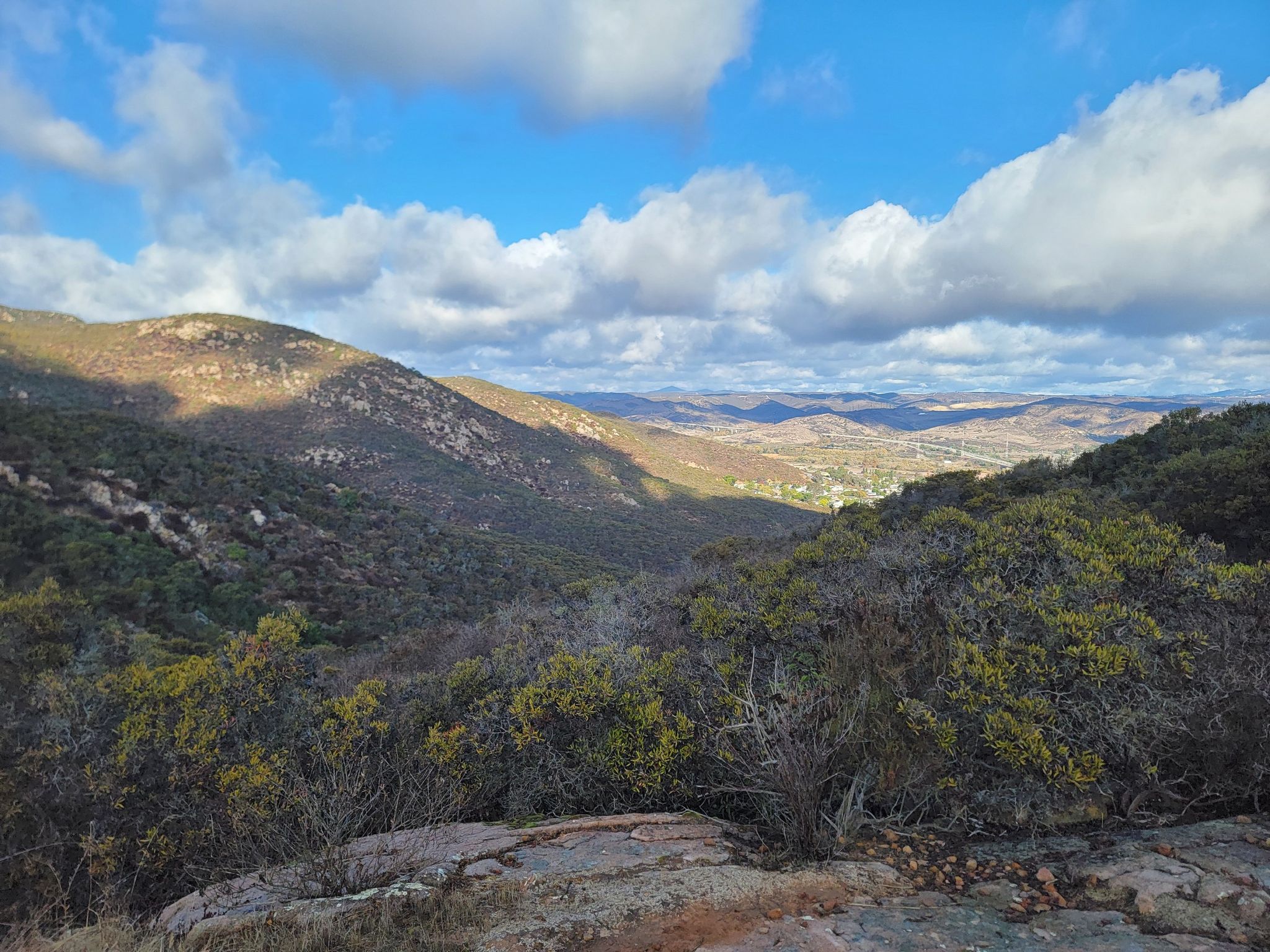 Sunny valley view with rolling hills and scattered clouds. - Big Rock and Mesa Trail Loop