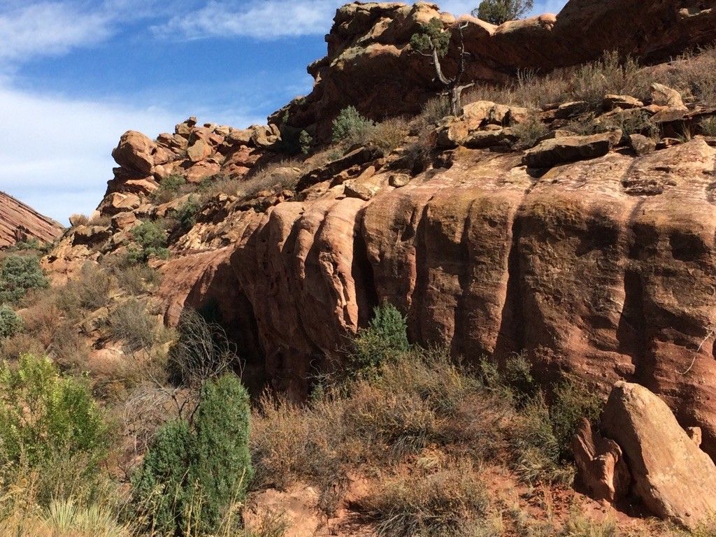 Majestic red rock formations with green shrubs under a bright blue sky. - Red Rocks Park Scenic Road – Red Rocks View Point loop from Aspen Park