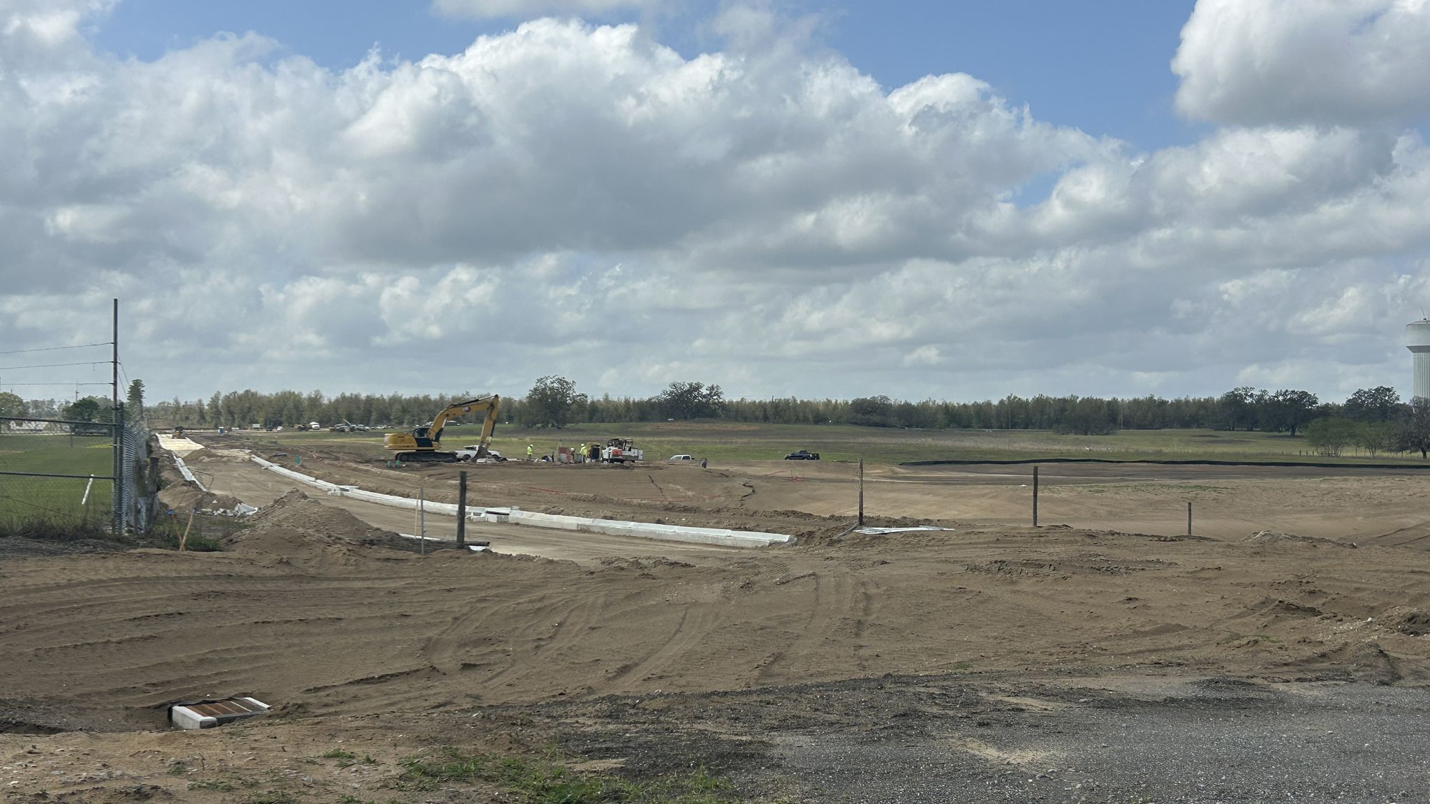 Large construction site with dirt, machinery, and cloudy sky. - Good Neighbor and Withlacoochee State Trail Loop