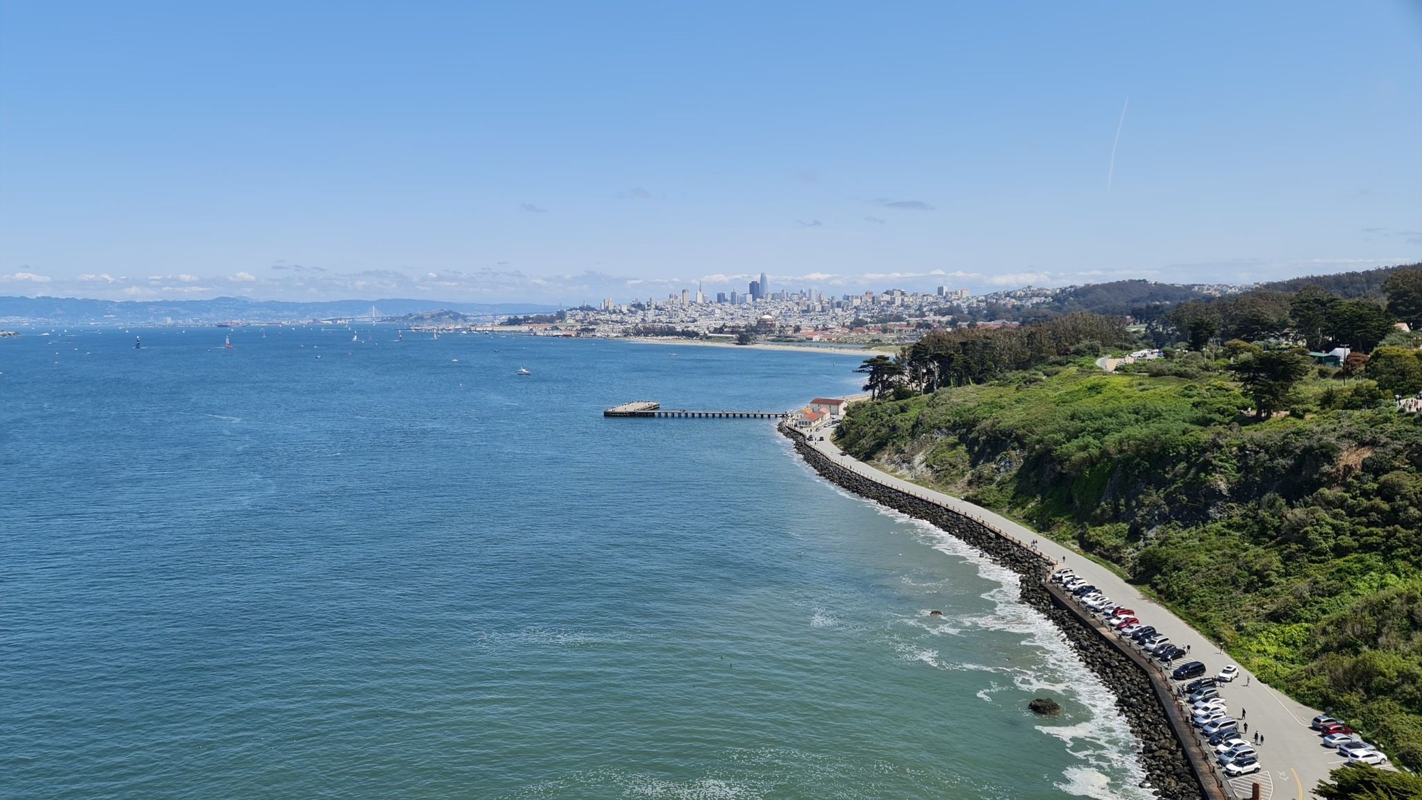 Coastal road and city skyline across a bay on a sunny day. - Bay Area Ridge Trail: Golden Gate Bridge