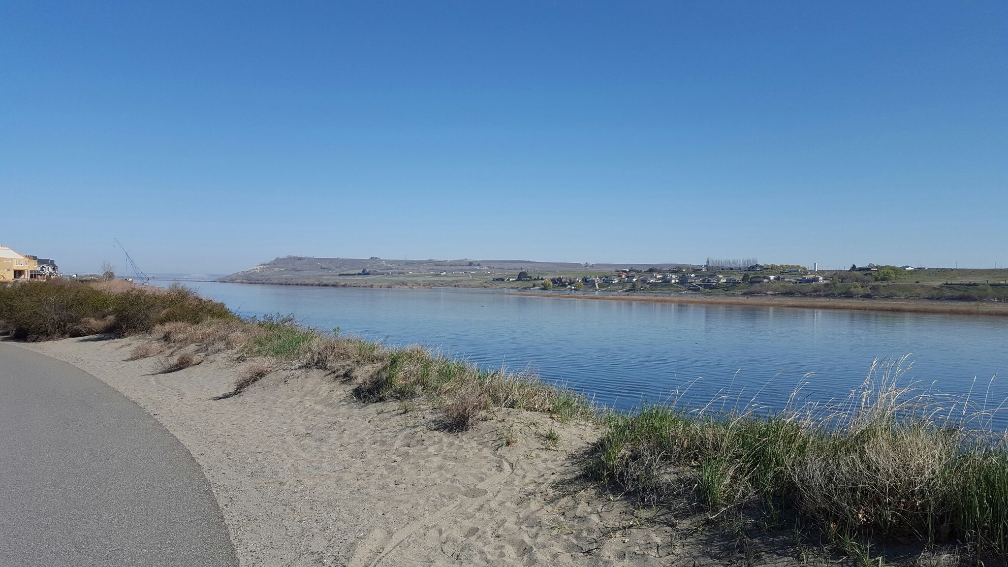 A paved path curves beside a river with sandy banks on a clear day. - Riverfront Trail – Chamna Natural Preserve loop from Washington State University - Tri-Cities