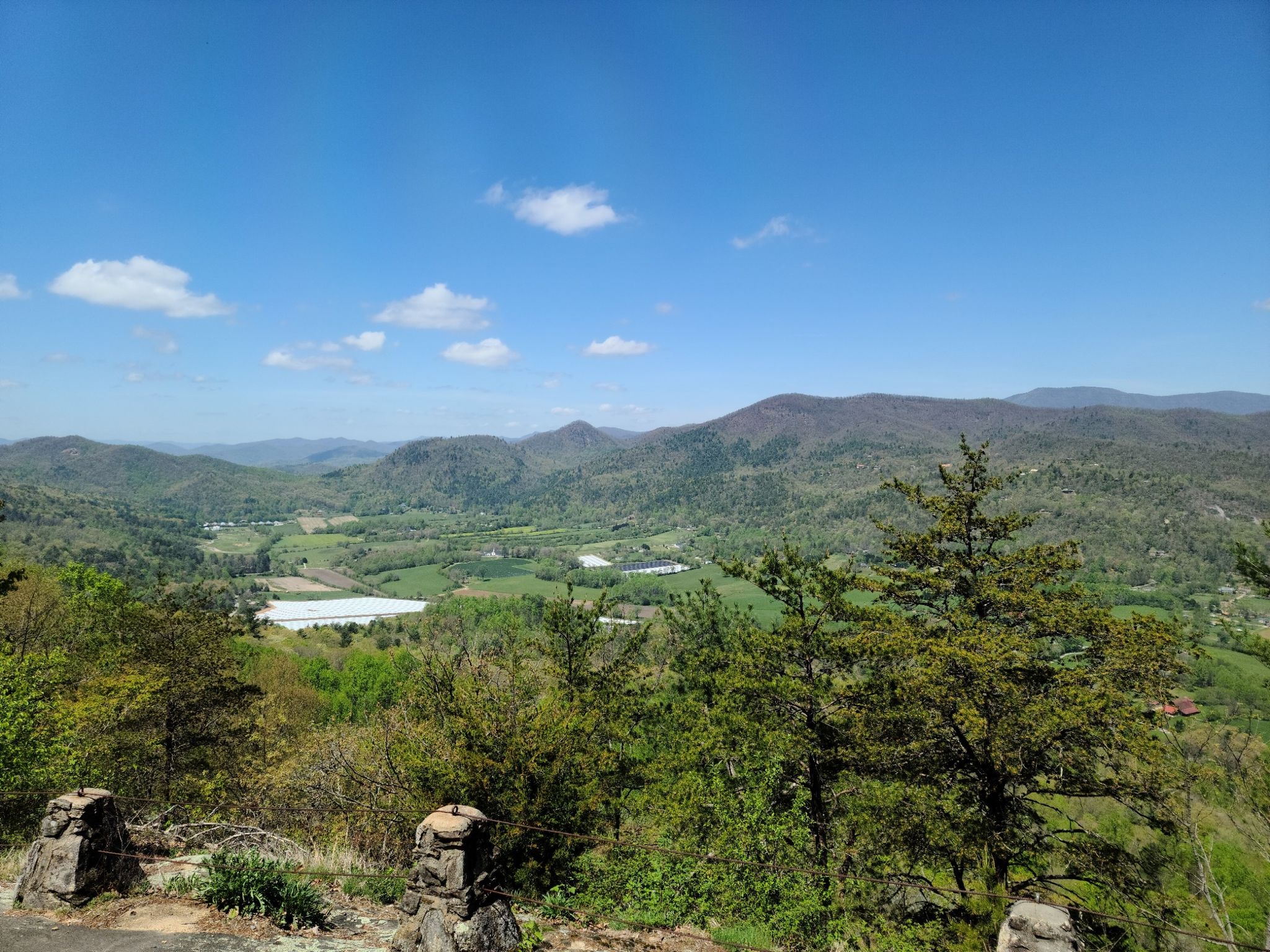 Expansive view of green mountains and a valley under a clear blue sky. - Lookoff Mountain via James Edmonds Trail Loop