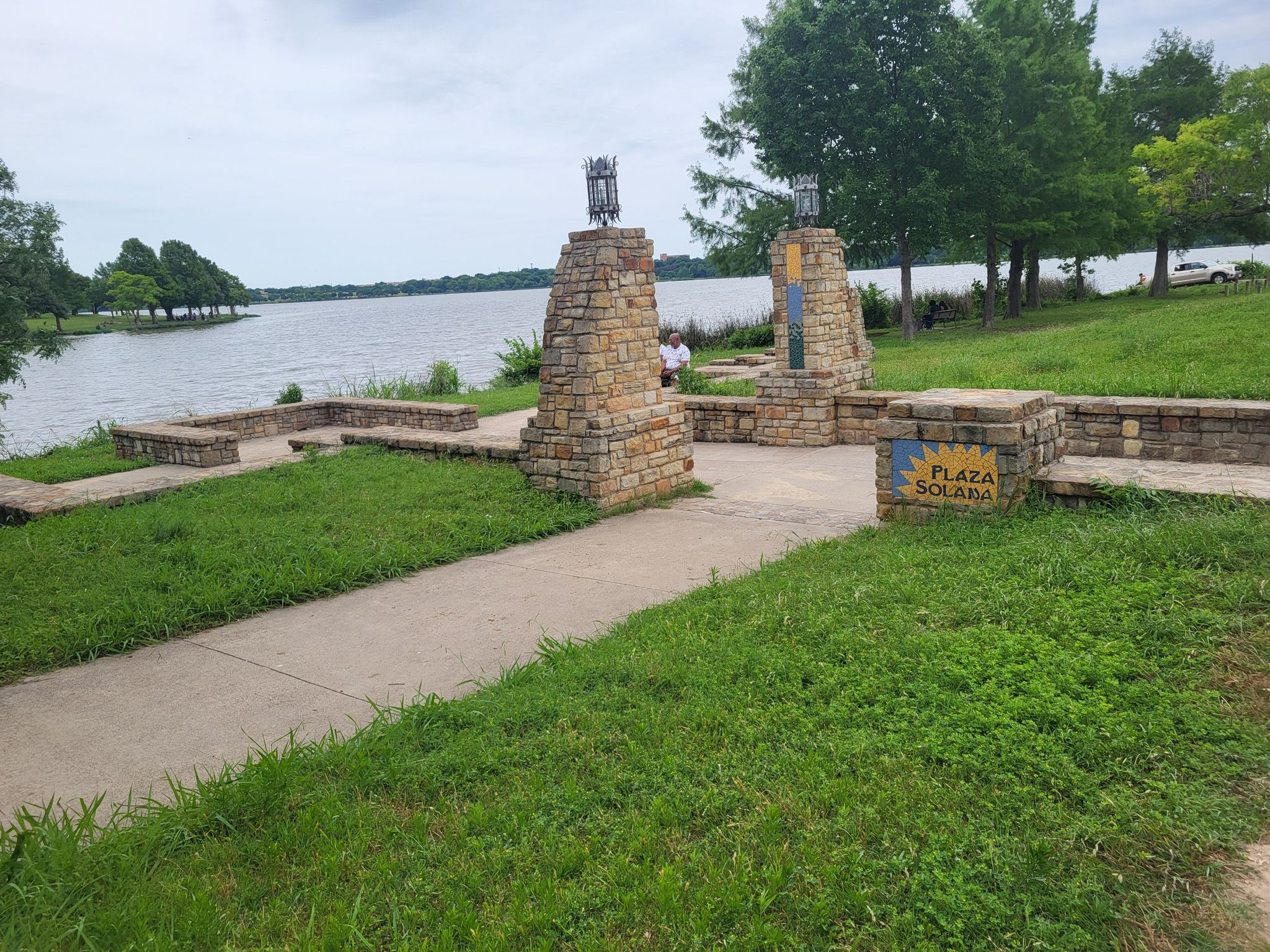 Stone pillars and low walls with a small sign, beside a large lake. - White Rock Lake – White Rock Lake Dam loop from LBJ/Skillman