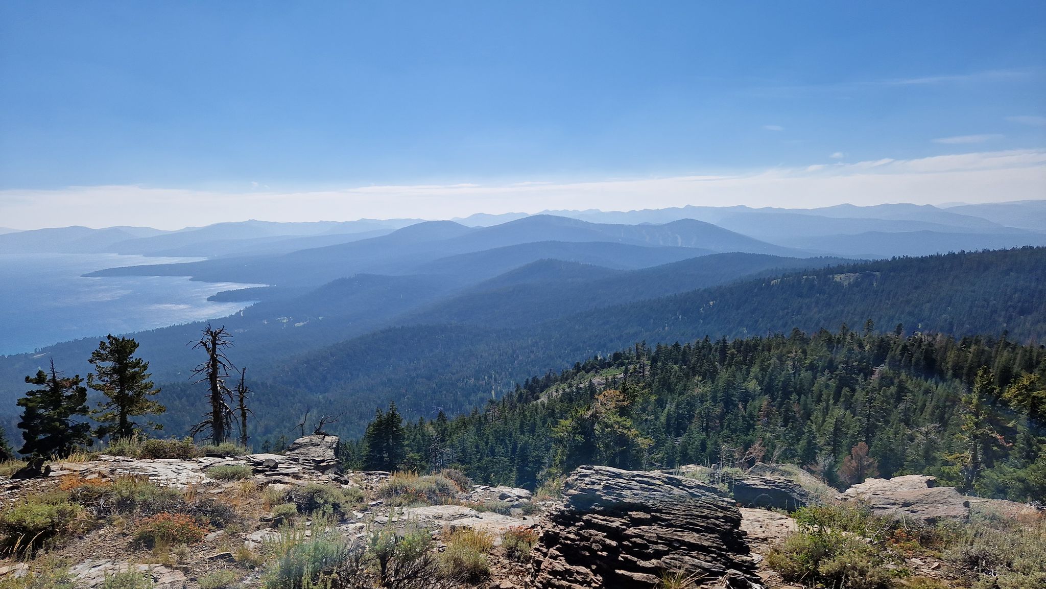 Panoramic view of a large lake and forested mountains under a clear blue sky. - Brockway Summit to Mount Baldy Loop