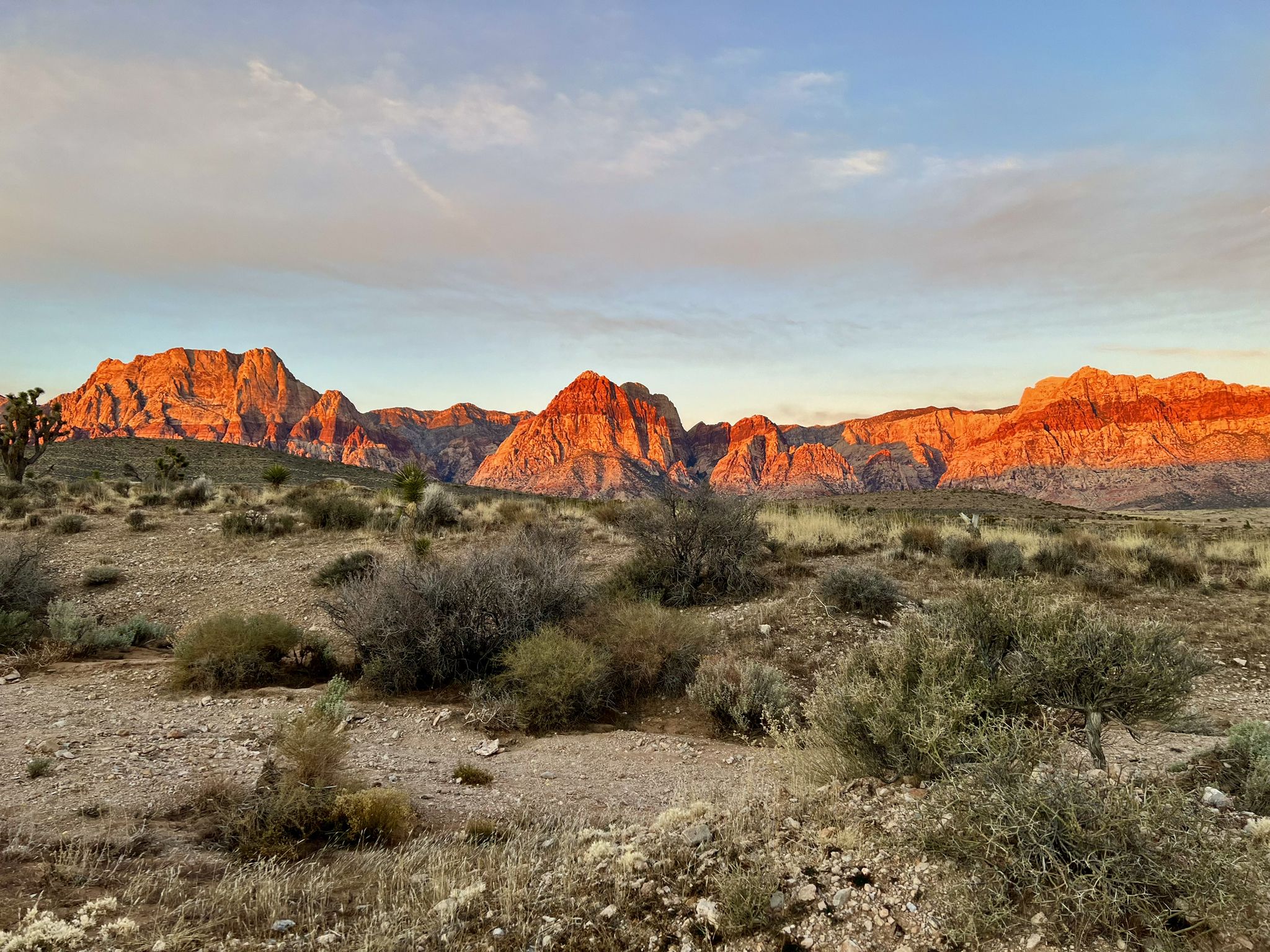 Desert mountains glow orange and red in the warm light of sunset. - Kibbles N' Bits loop — Cowboy Trails