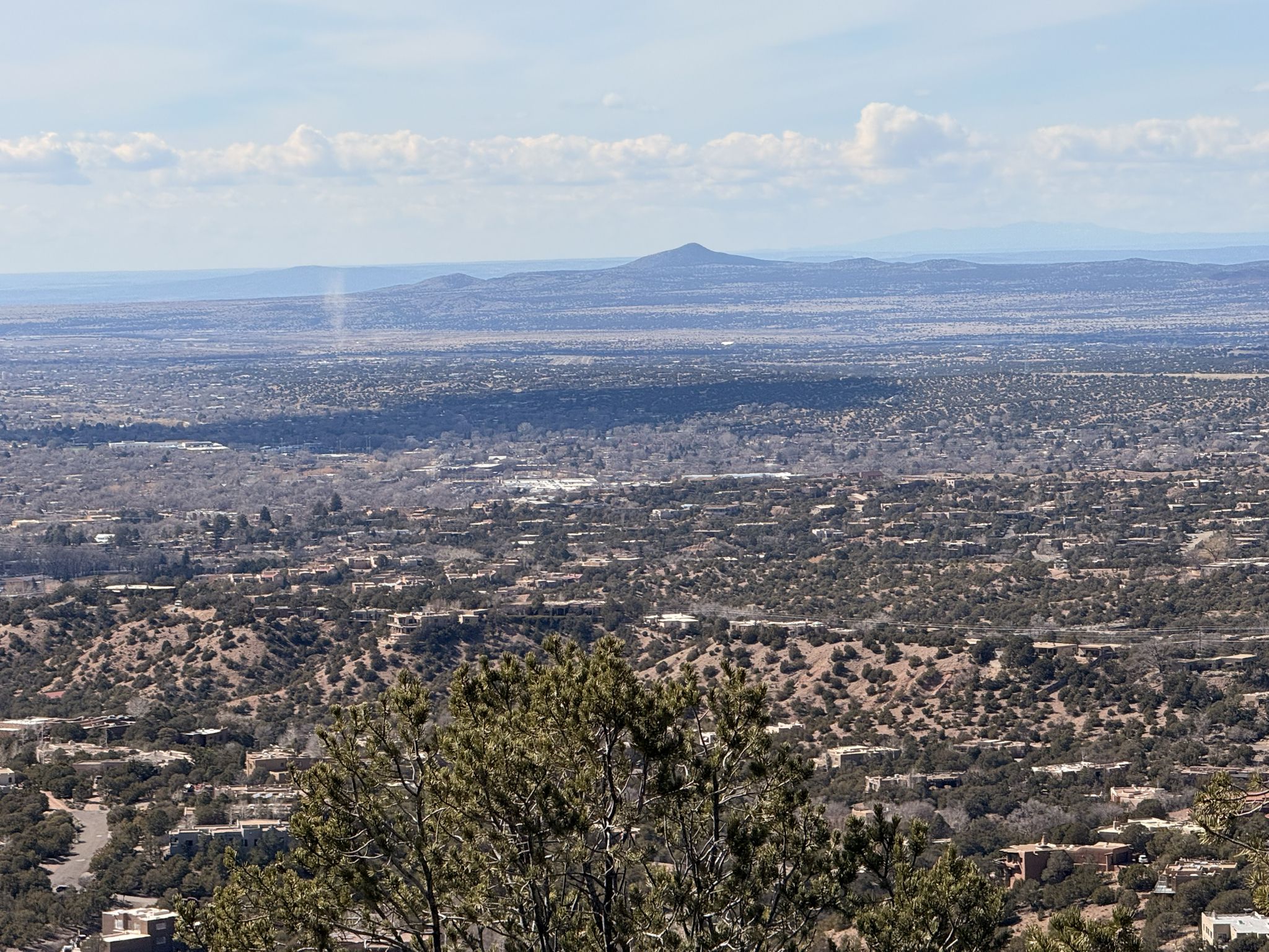 Panoramic view of a sprawling city and distant mountains under a bright sky. - Dale Ball Trails North loop