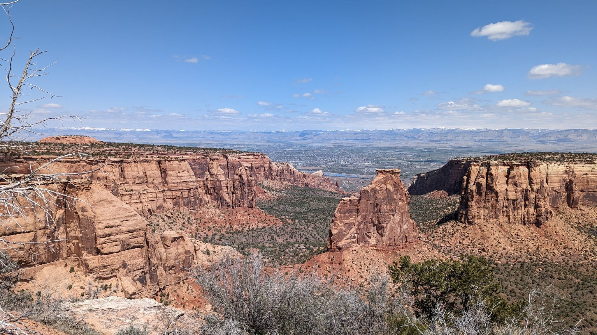 Expansive canyon vista with towering rock spires and distant mountains under clear blue sky. - Coke Ovens Overlook – View of Balanced Rock loop from Kindred Reserve