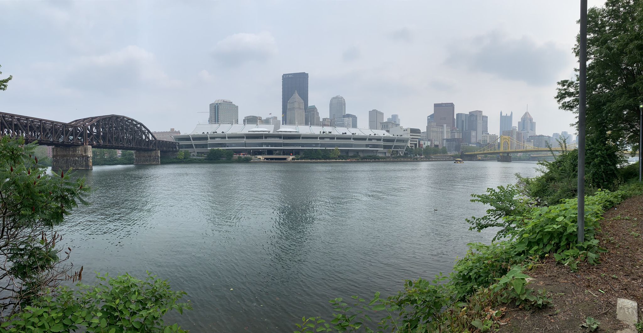 Panoramic view of a city skyline and two bridges over a wide river. - North Shore Trail – Heinz Factory Complex loop from Allegheny