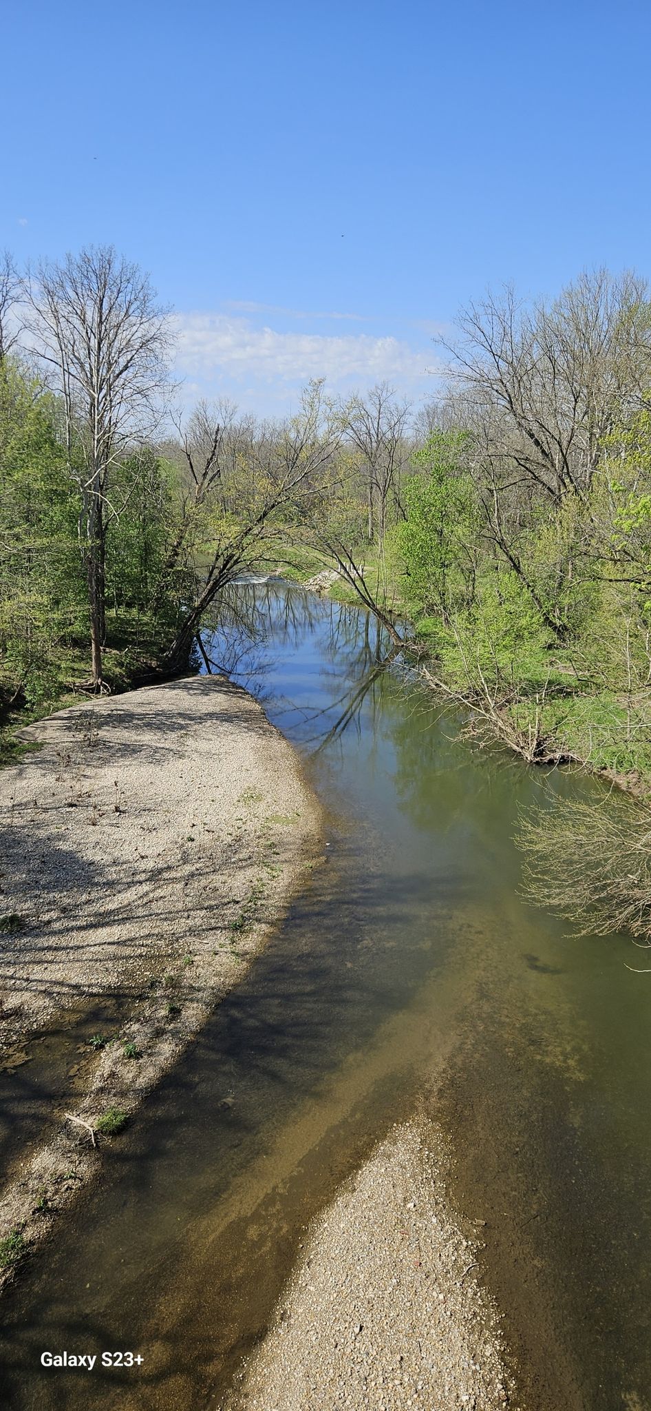 Sunny view of a winding river with sandy banks and green trees. - Big 4 Rail Trail (Zionsville) loop from Saint Alphonsus Liguori Catholic Church