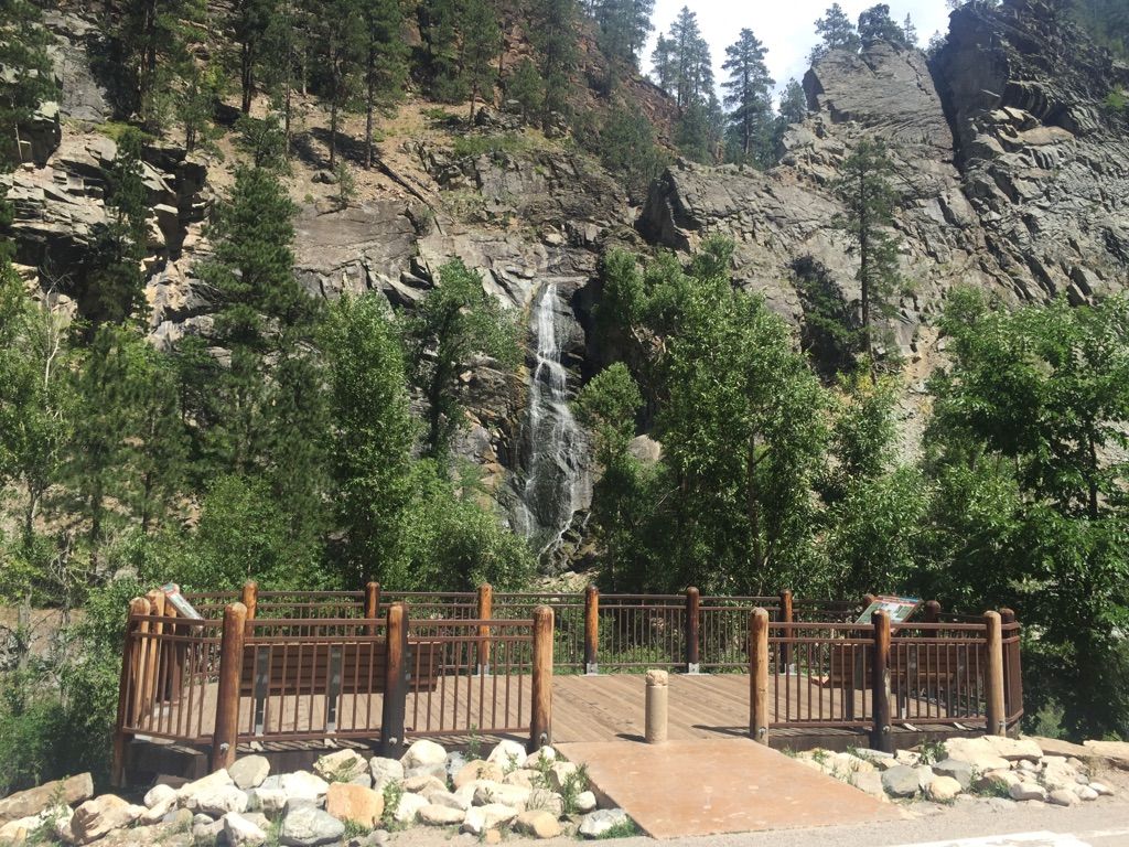 Waterfall cascading down a rocky cliff, viewed from a wooden platform. - Bridal Veil Falls loop from Ward 2