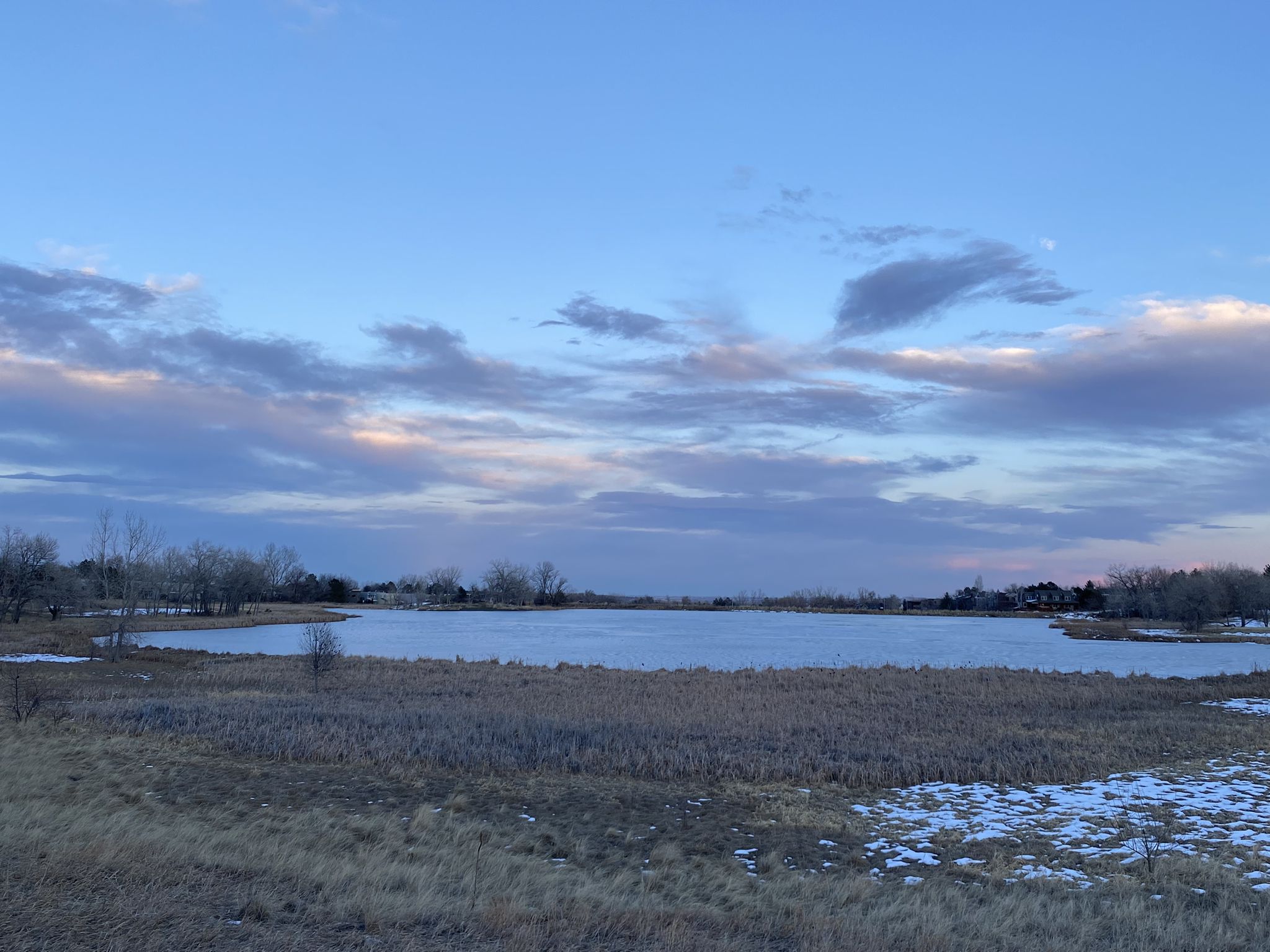 Frozen lake at dusk, surrounded by dry reeds under a cloudy sky. - Wonderland Lake – Wonderland Lake loop from Violet on Broadway