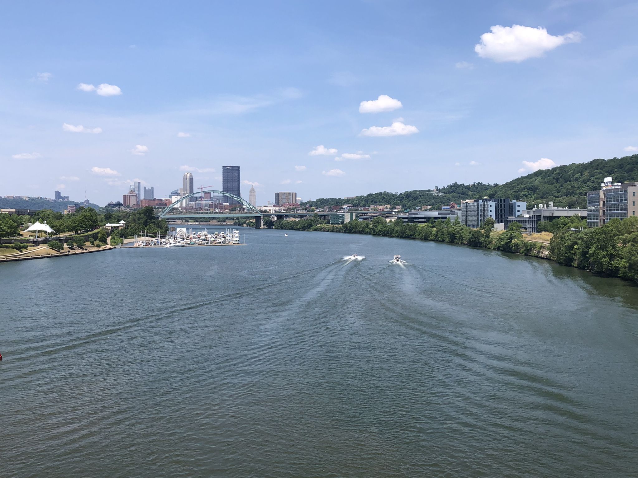 River with boats, city skyline, and bridge under a bright blue sky. - Three Rivers Heritage Trail and Sewickley Loop