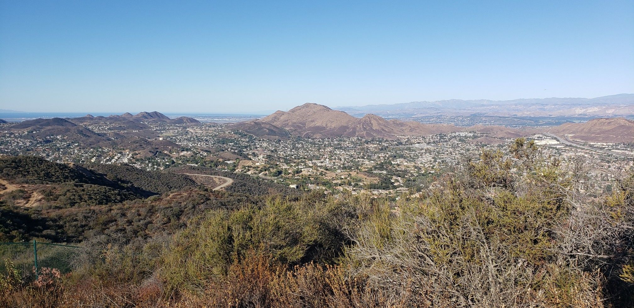 Expansive view of a town nestled among hills under a clear blue sky. - Space Mountain and Rosewood Trail Loop