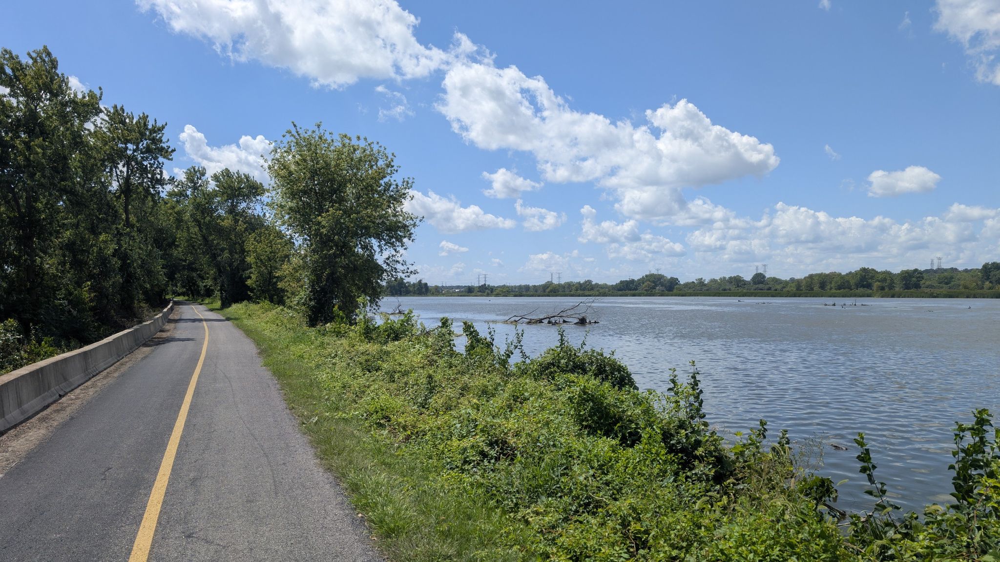 A paved path runs alongside a wide river under a bright blue sky. - Centennial Trail – Centennial Trail loop from Lemont