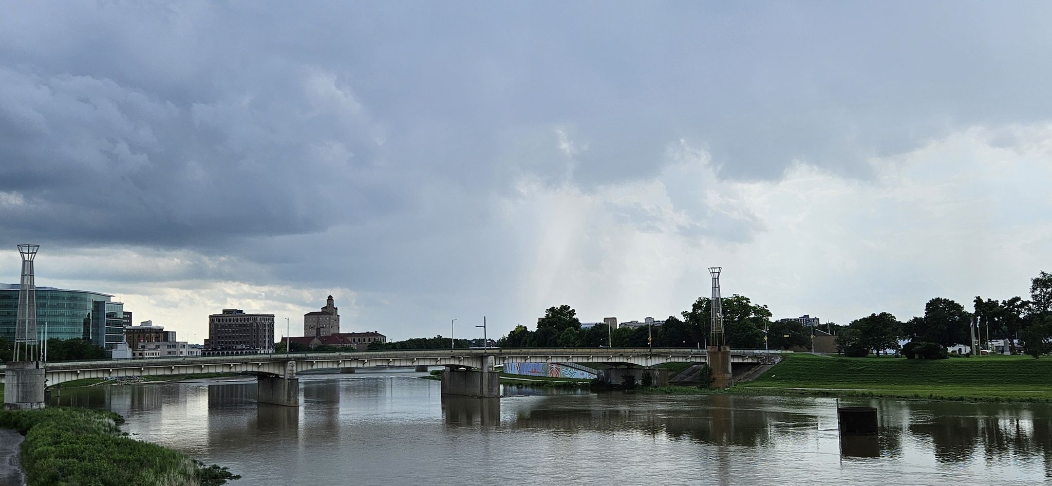 A city skyline and bridge over a river under a cloudy, stormy sky. - Five Rivers Fountain of Lights – Eastwood Metro Park loop from Parking for Stan the Donut Man