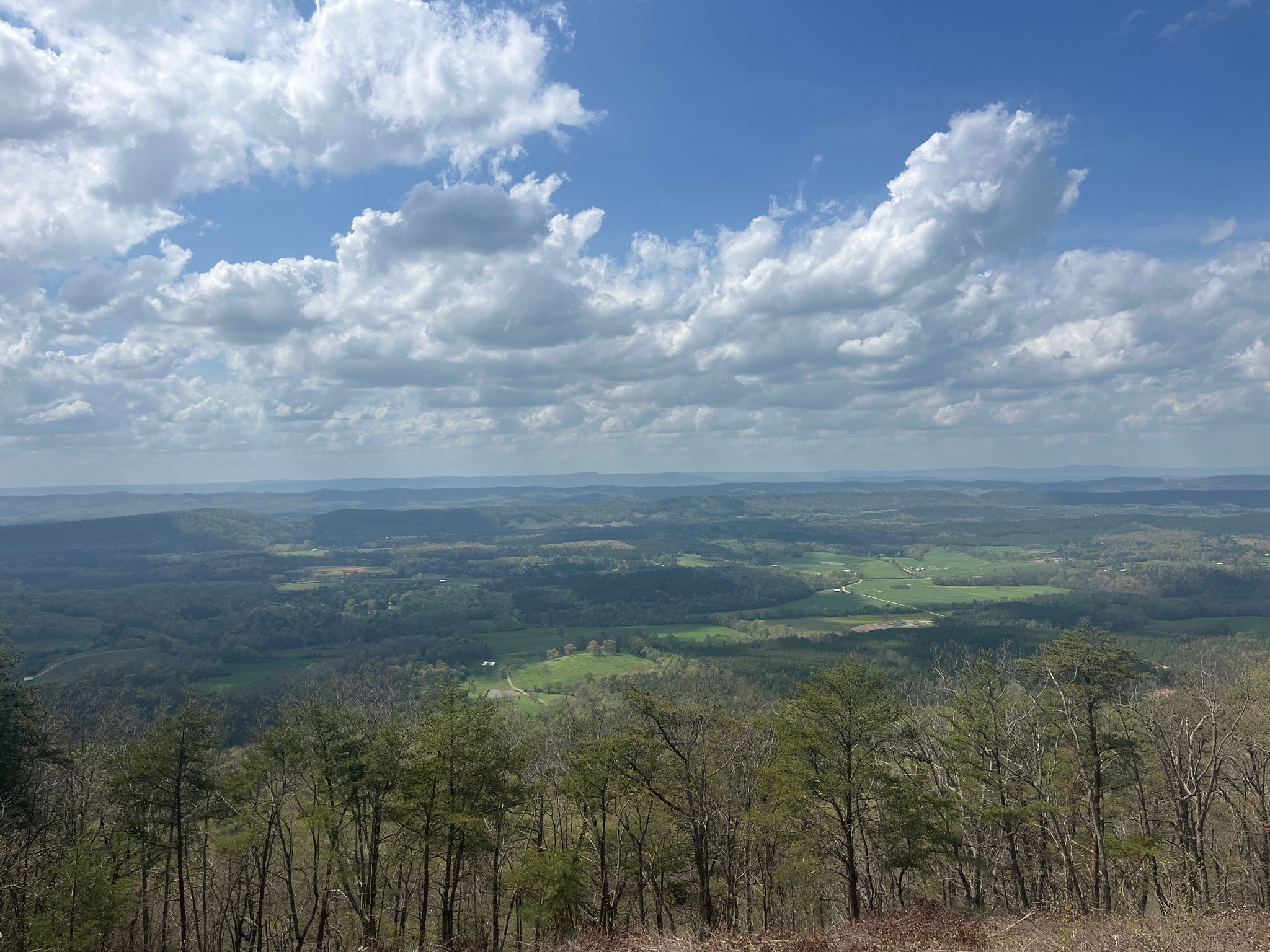 Panoramic view of a vast green valley under a bright, cloudy sky. - Johns Mountain Loop Trail
