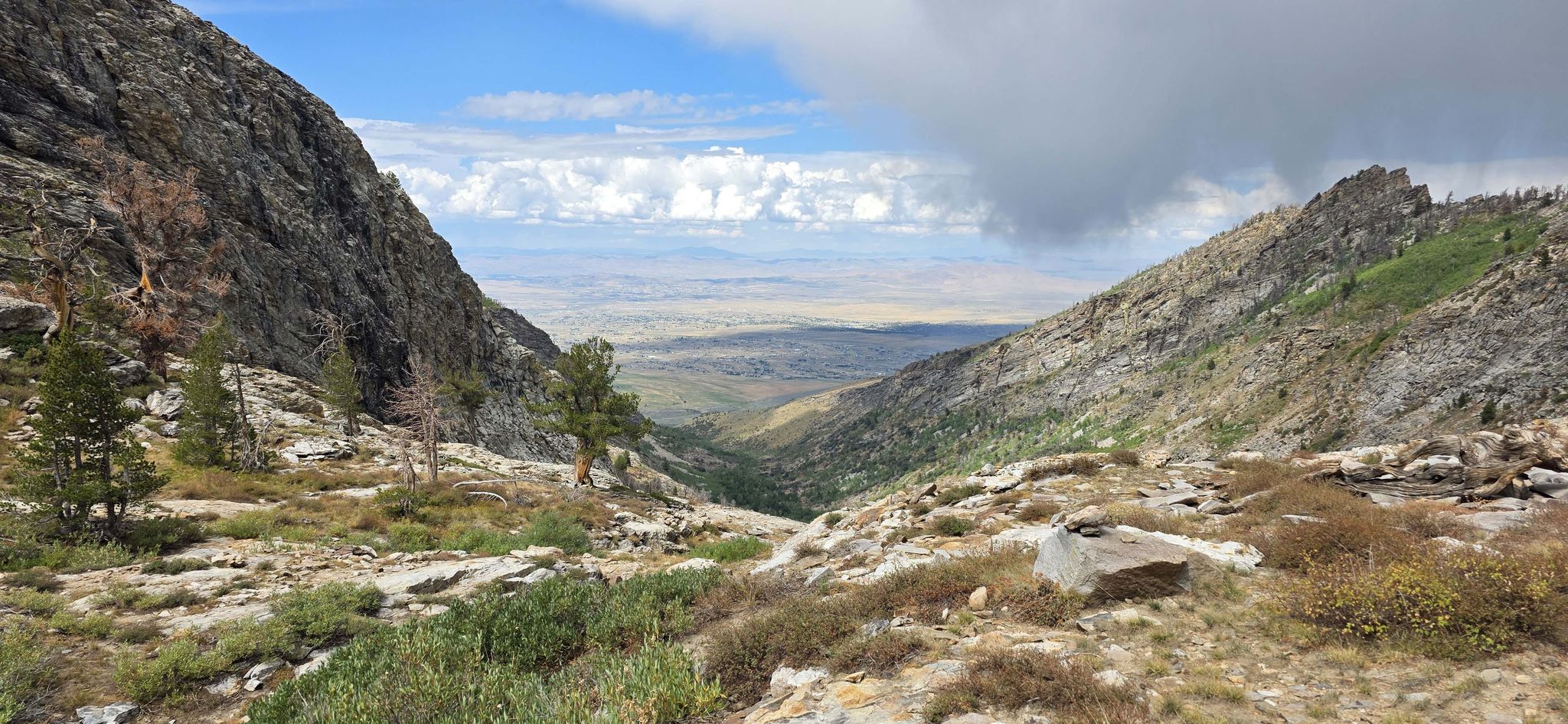 Mountain valley with distant plains under a partly cloudy sky. - Ruby Dome via Hennen Canyon Trail