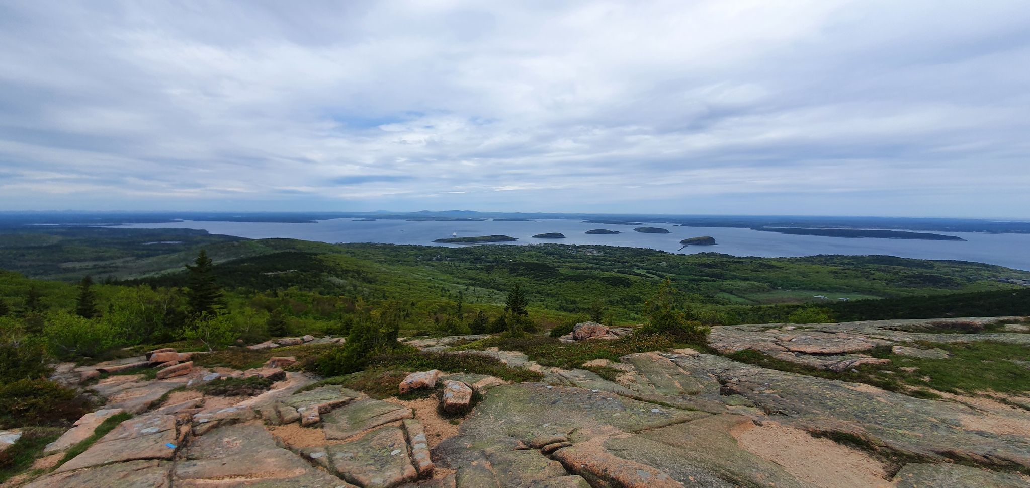 Panoramic view from a rocky mountain top overlooking a large bay with islands. - Cadillac North Ridge – View of the Acadia Archipelago loop from Bar Harbor